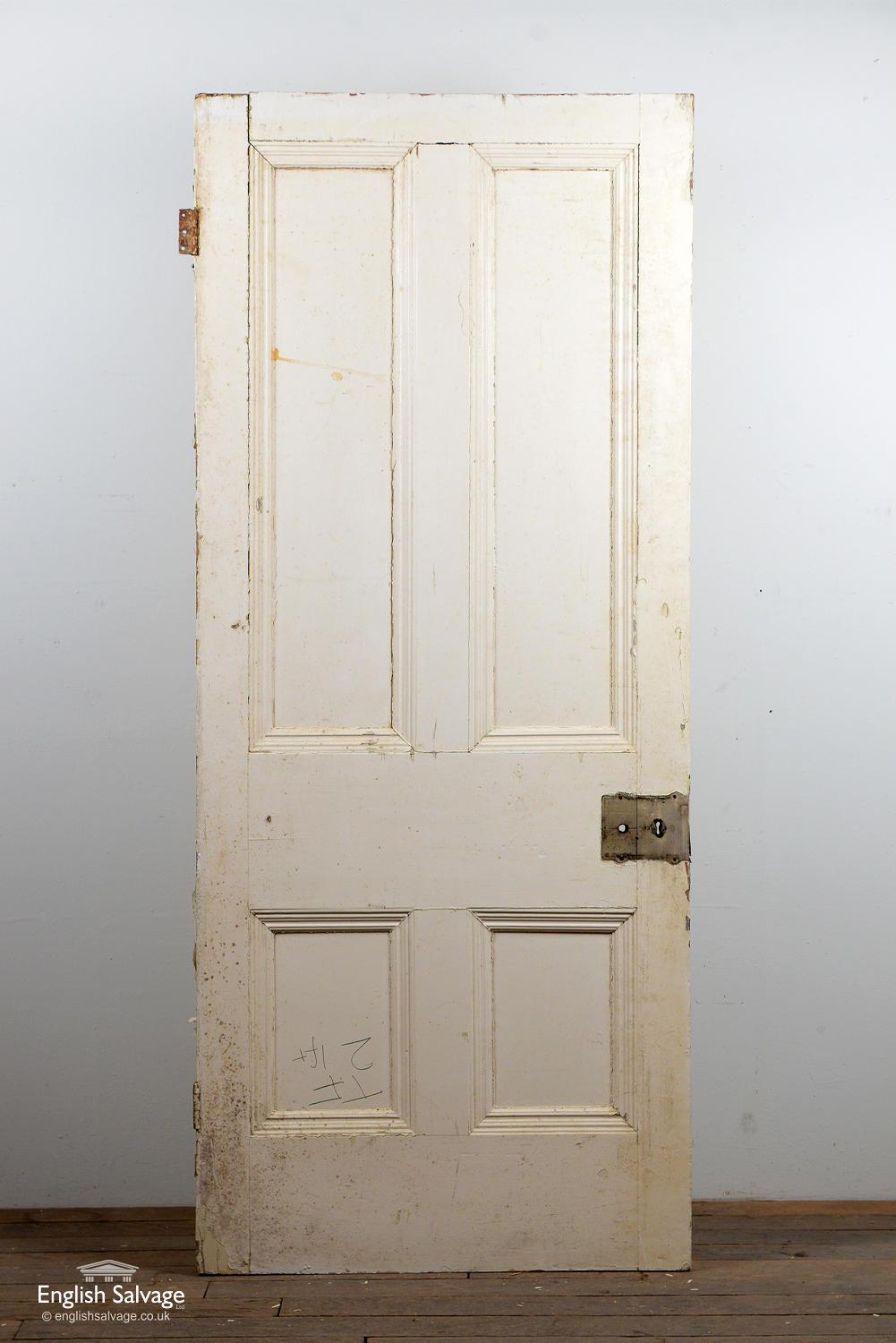 Victorian door with four beaded panels. Chipped paint, handle, lock and nails holes.