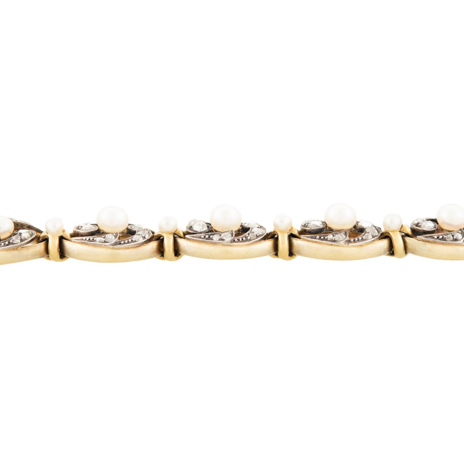 A stunning pearl and diamond bracelet from the Victorian (ca1880s) era! Crafted in 18k yellow gold and topped in sterling silver, this bracelet features 10 oval-shaped links. Each link features a central pearl, with each stone display a lovely