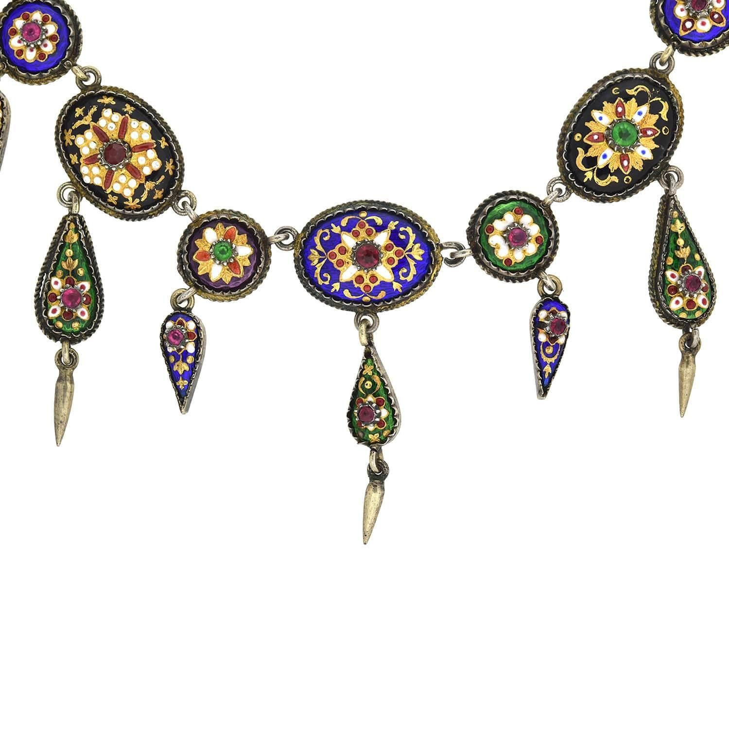 An absolutely stunning French Bresse Bressan enameled necklace from the Victorian (ca1880s) era! Crafted in sterling silver, this wonderful piece features incredibly vibrant enameled designs paired with French paste stones. Twenty seven round and
