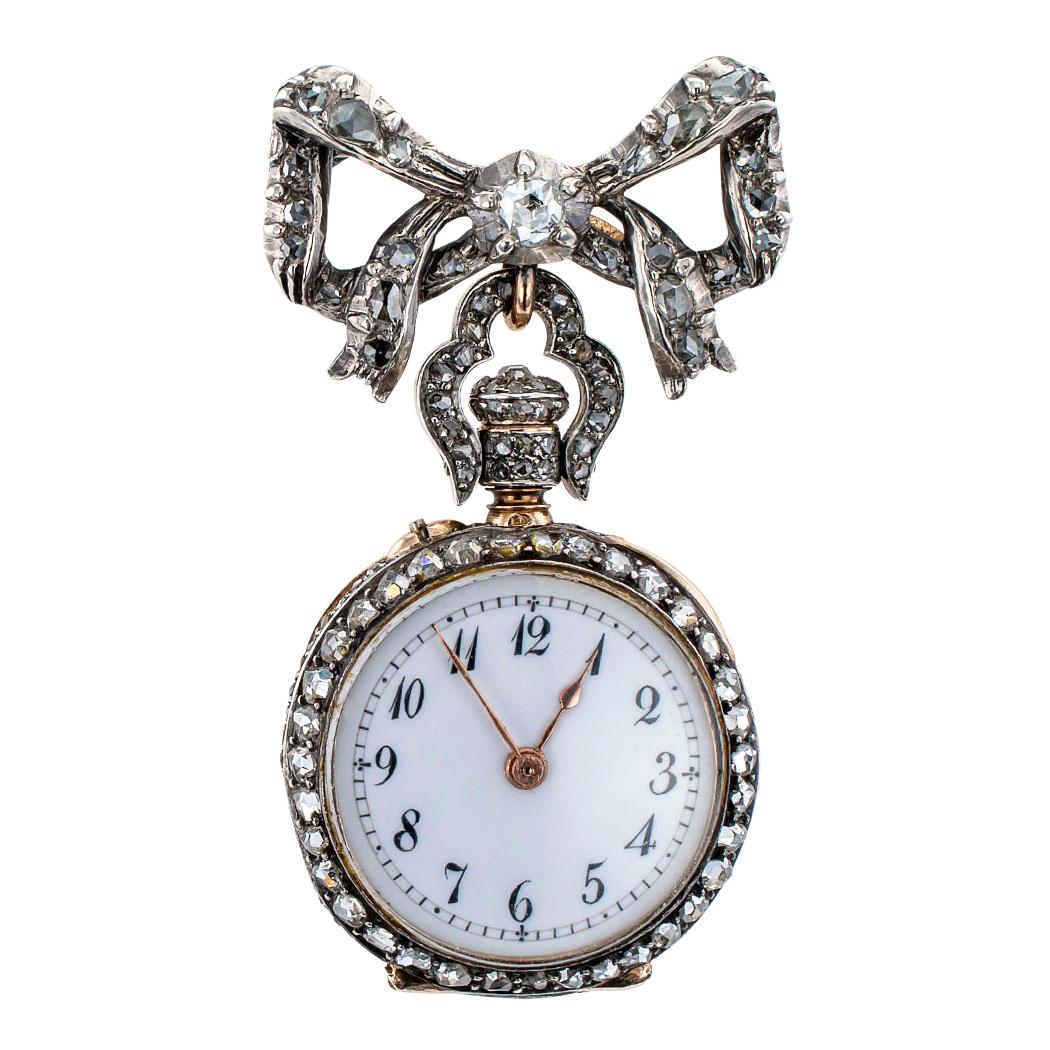 French Victorian brooch watch set with rose-cut diamonds and mounted in 18-karat gold and silver circa 1860. The round design features a white dial, black Arabic numerals and secondary markers within a rose-cut diamond bezel to the back cover and