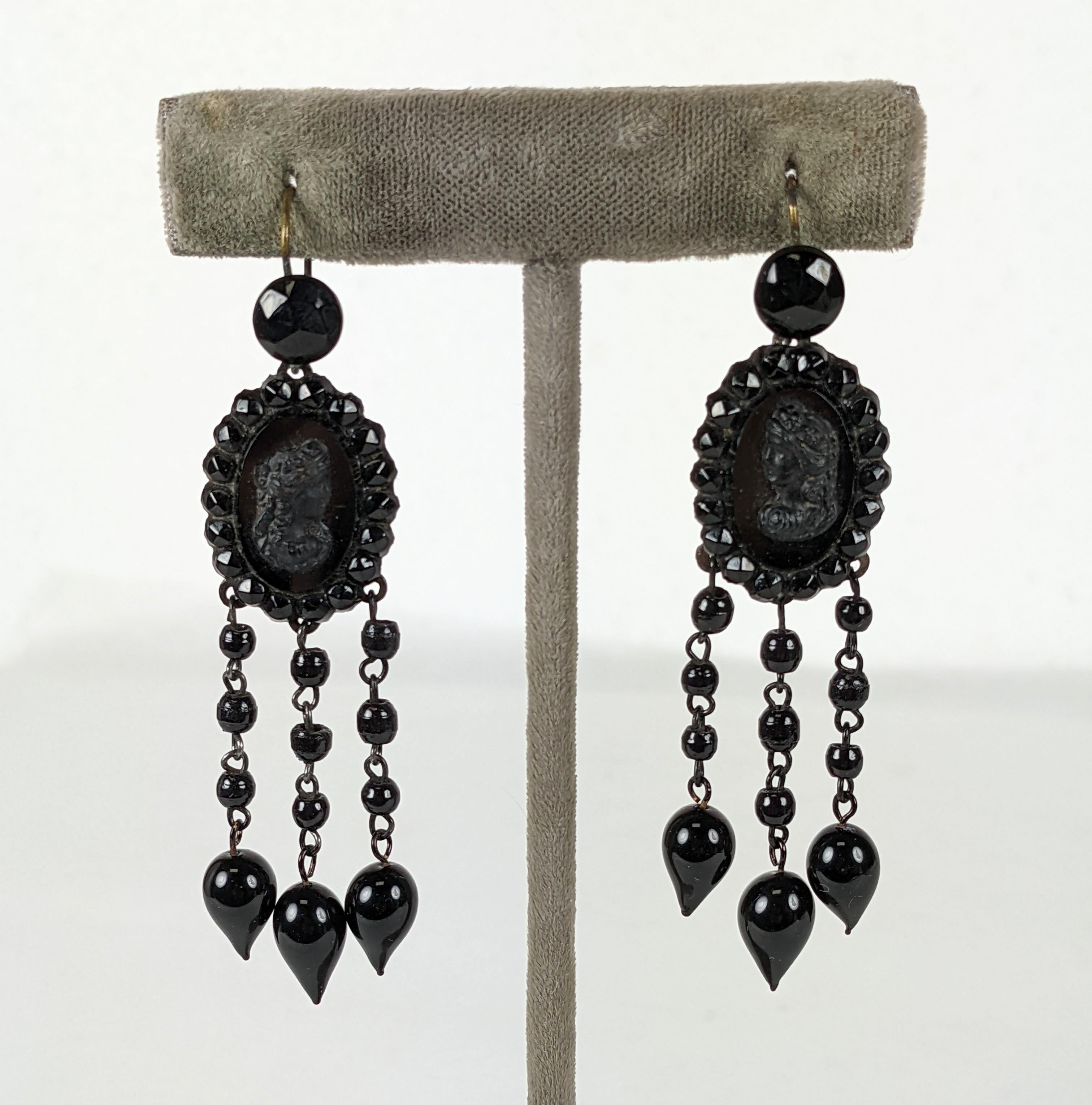 Victorian long french jet earrings of faceted and smooth jet cabocheons, round beads and tear drop shaped drops. With focal cameo ovals facing one another. Blackened steel fittings. Excellent Condition, French wire ear hooks. 
Length  2.75