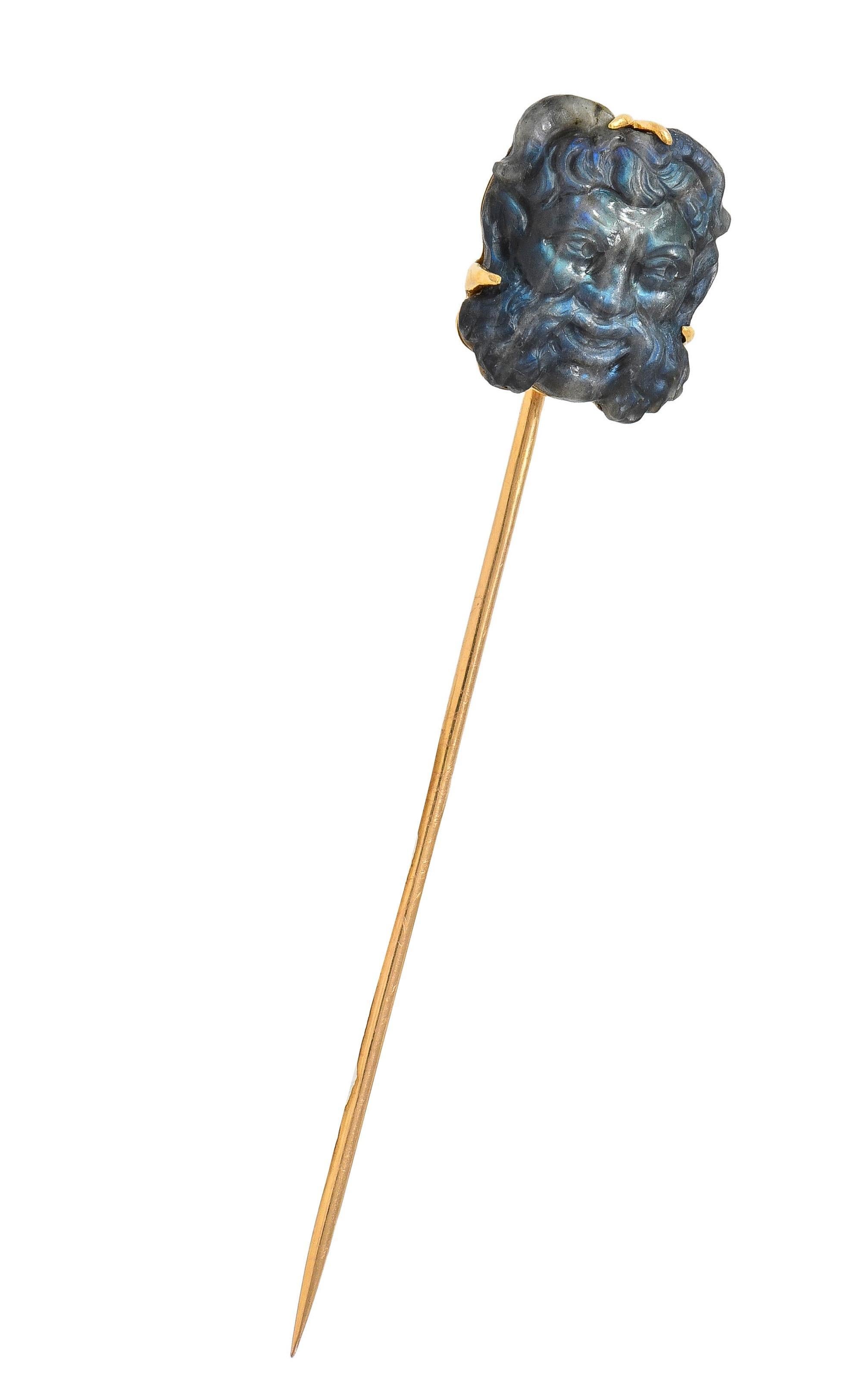 Comprised of a carved cushion-shaped labradorite tablet depicting the Greek god Pan
Designed with curling horns, pointed ears, swirling hair, and a mischievous expression
Translucent gray with dark striations and strong vivid blue