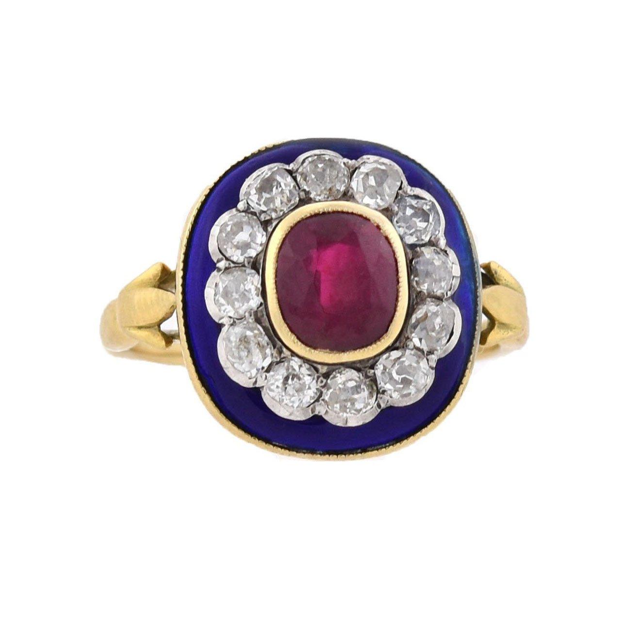 An exquisite and unique ruby and diamond ring from the Victorian (ca1880) era! French in origin, this gorgeous piece is crafted in vibrant 18kt yellow gold and features sterling silver accents. The raised, oval-shaped centerpiece displays a natural,