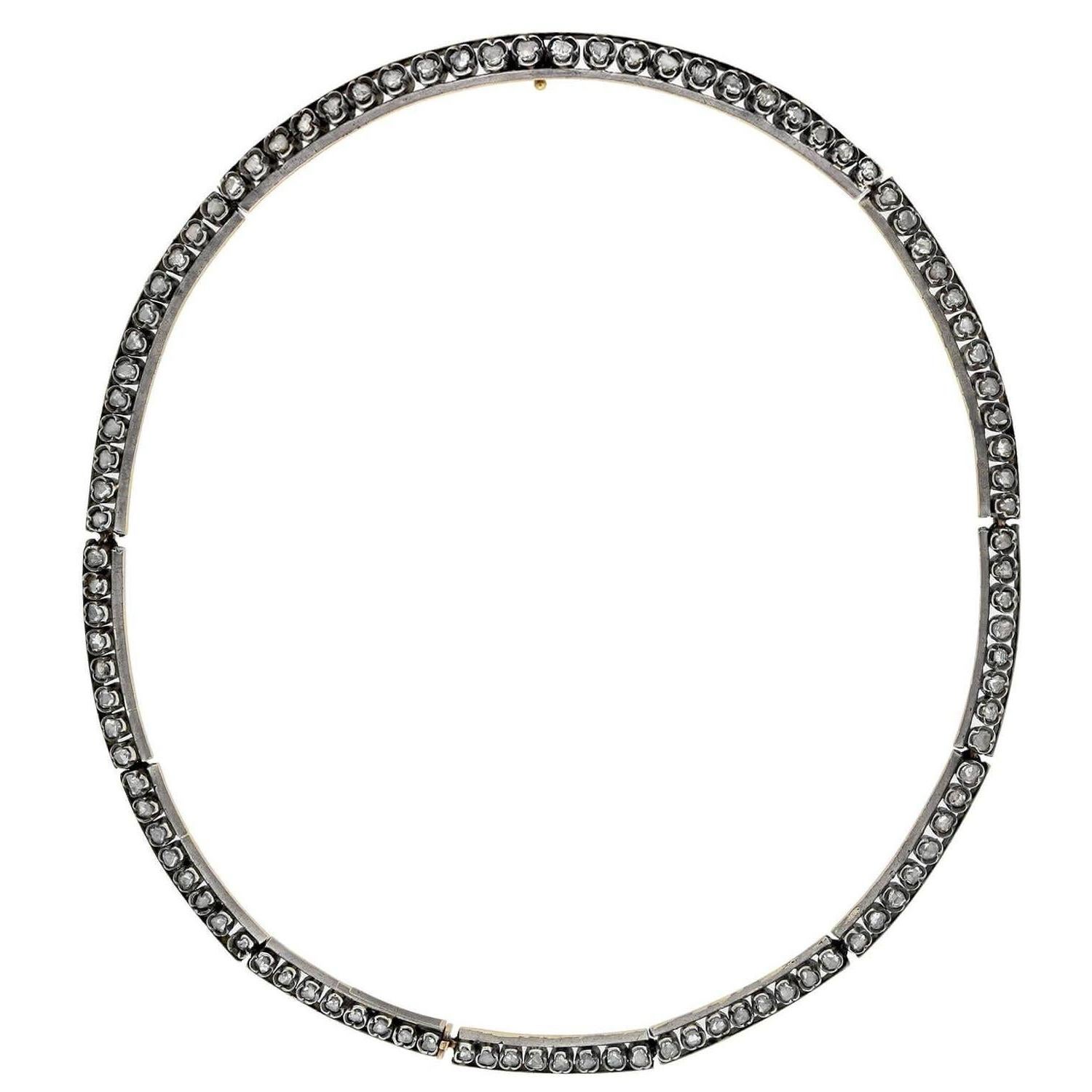 An absolutely gorgeous diamond necklace from the Victorian (ca1880) era! This stunning French-made piece is crafted in sterling-topped 18kt yellow gold and has a collar-length design. The necklace is comprised of 10 curved panel links, each formed