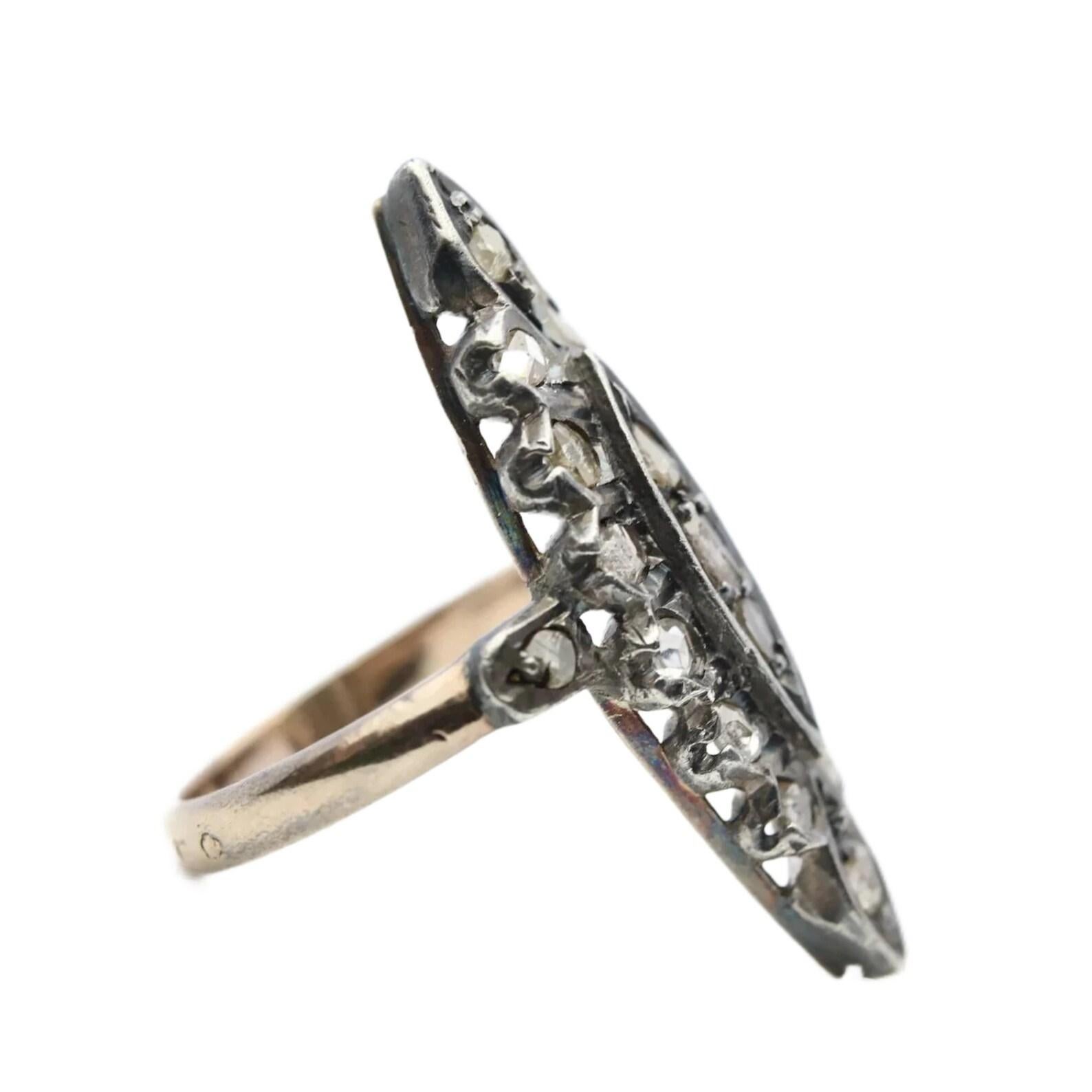 A handmade victorian period rose cut diamond naivette shaped ring in 18 karat gold and silver. Bearing French hallmarks on the shank, this mid 19th century ring features 19 antique rose cut diamonds set in richly patina'd silver.

In excellent