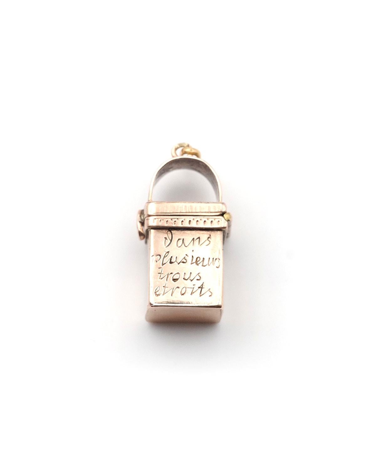 Victorian secret locket pendant in 14k rose gold. Secret pendant in the form of an architectural element, a well or a chimney, opening at the top to conceal an object or sentimental item. The pendant bears the inscription 