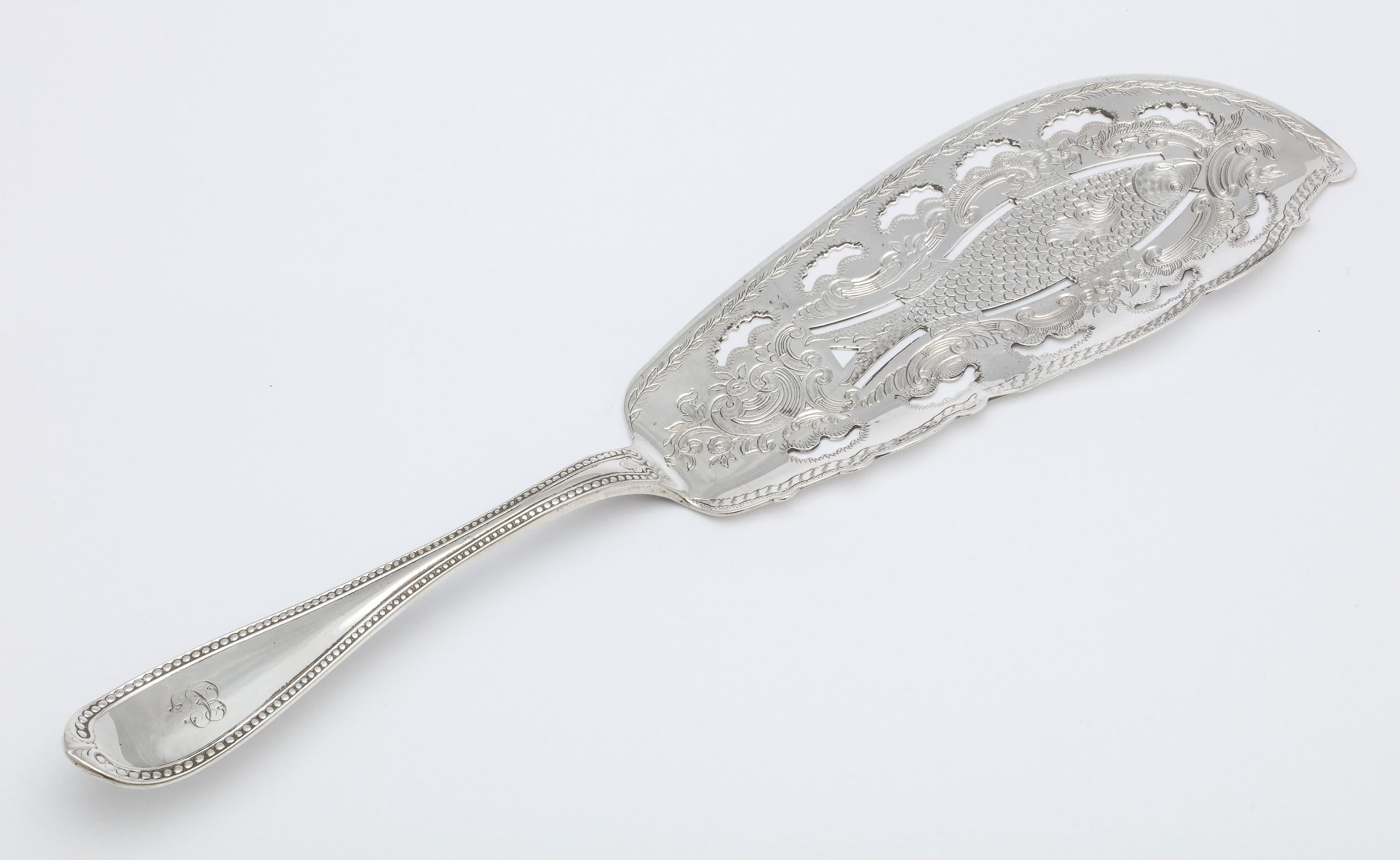 Victorian, French, sterling silver fish slice/knife, Tiffany & Company, Paris, circa 1870.
Blade is pierced and is designed with an etched fish. Handle is beaded. Measures: 11 3/4 inches long x 3 inches wide (at widest point x 1/2 inch high when