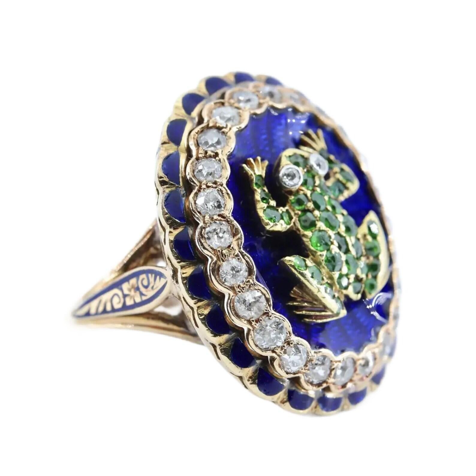 A victorian period ring centered by demantoid garnet set frog atop a bed of rich blue enamel.

The frog adorned with 33 old mine cut demantoid garnets; and a pair of old mine cut diamond eyes set in bezels of platinum.

Surrounded by rich blue
