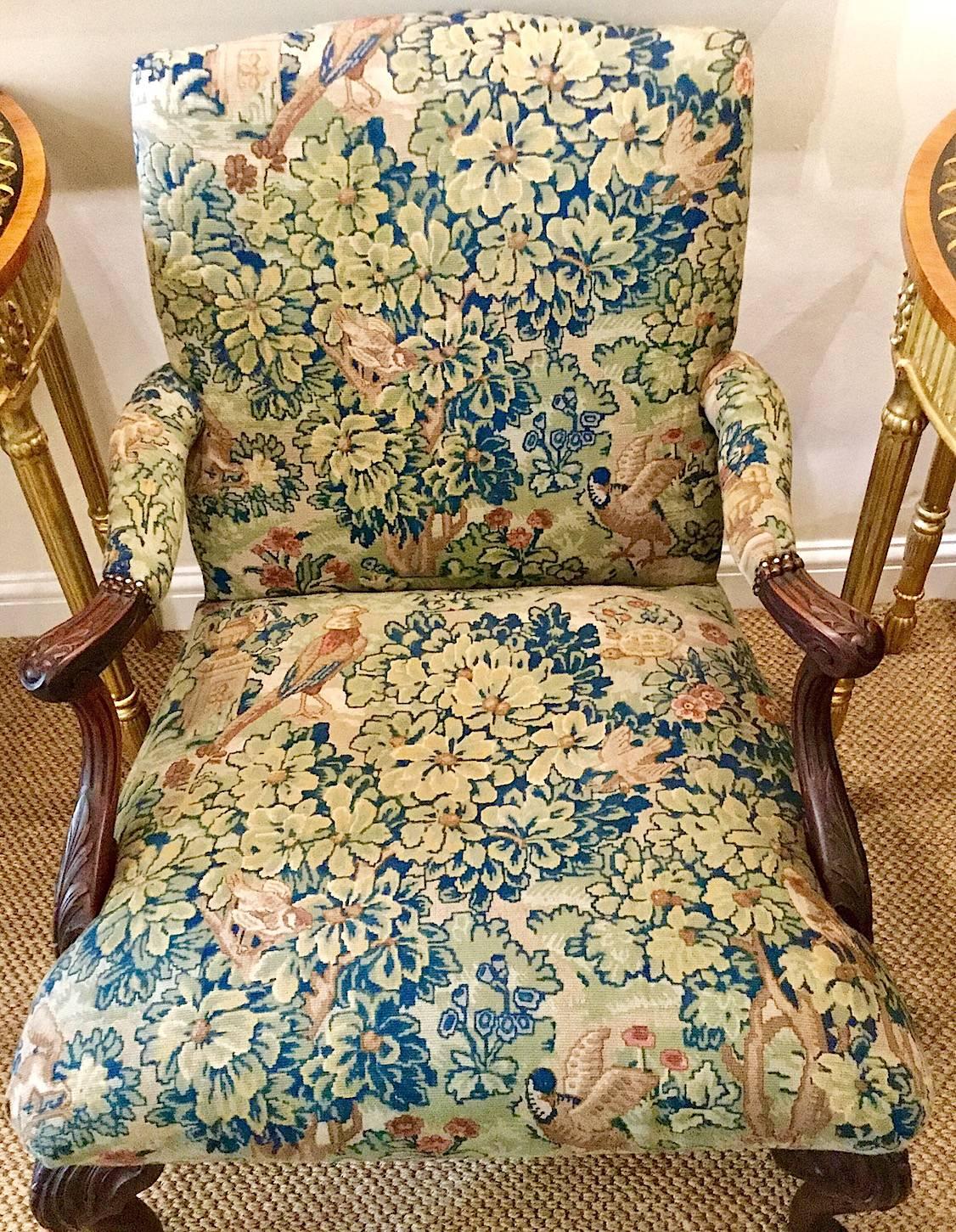 A Victorian George III style mahogany framed 'Gainsborough' armchair. This 'Gainsborough' style chair is from Ireland. It is upholstered in a Classic tapestry fabric with birds and foliage. Detailed carving on the arms and legs. It is very
