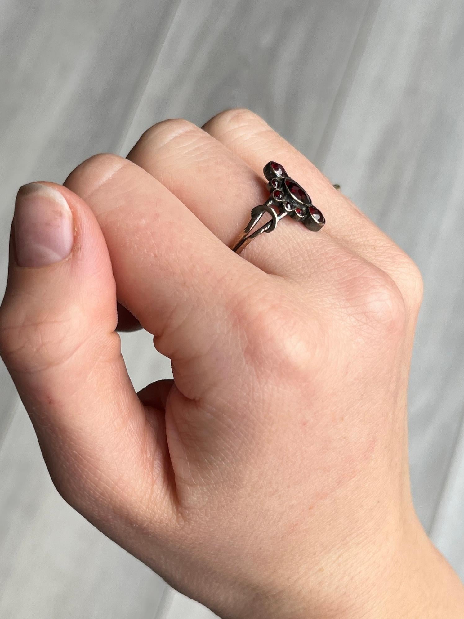 The victorian garnet stones in this navette cluster ring are a gorgeous deep red and are so glossy. Modelled in 9carat gold with decorative shoulders. 

Ring Size: Q or 8 
Cluster Dimensionsr: 15x11mm 

Weight: 1.6g