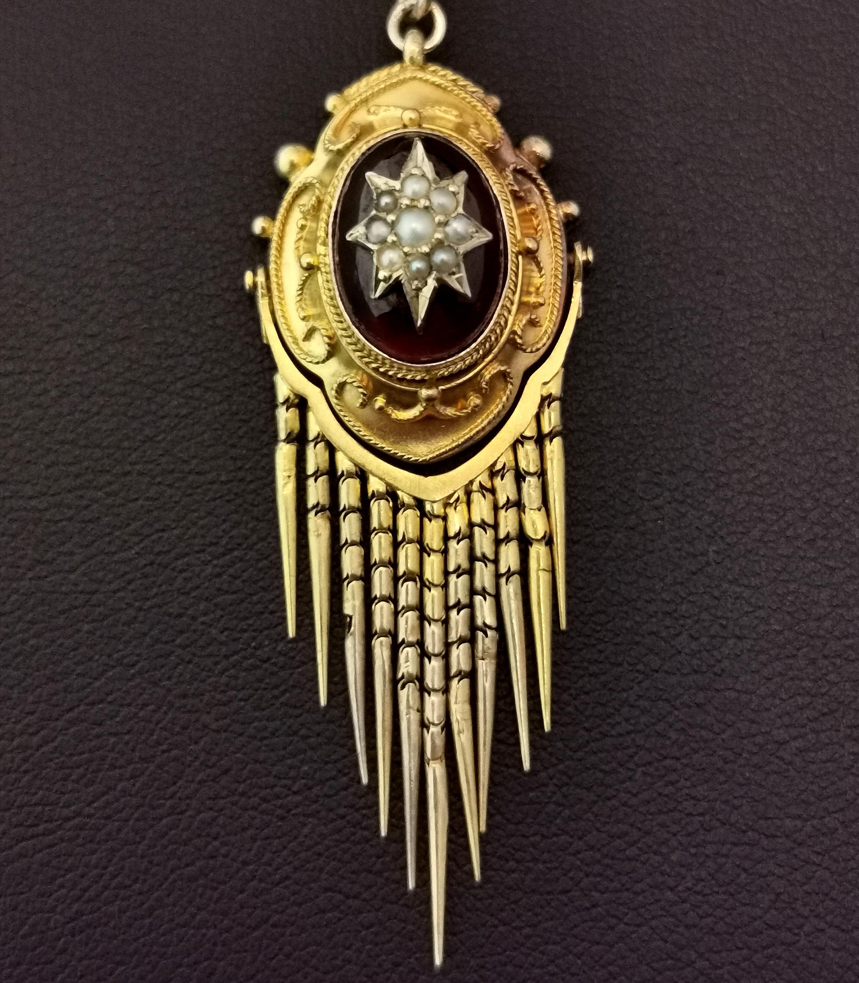 An impeccable antique, Victorian Bohemian garnet and pearl tassel pendant and necklace.

This stunning piece is a day and night pendant, the shimmery foxtail fringe can be unclipped from the body to create a more sophisticated day look and added for