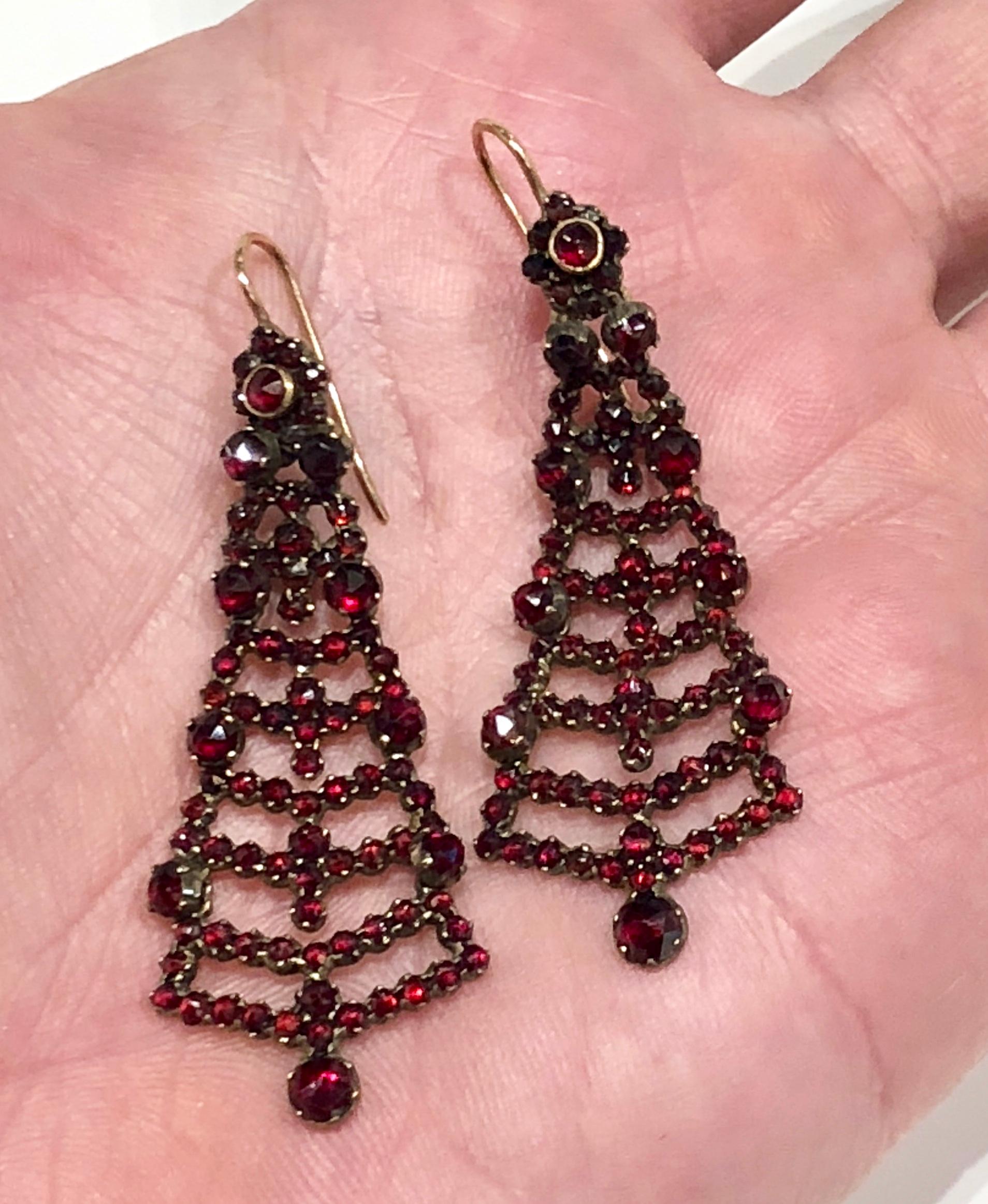 Set in garnet gold with 9k wires , Victorian earrings with tiered chandelier style. Deep red rose cut garnets covering the entire face of earring front.