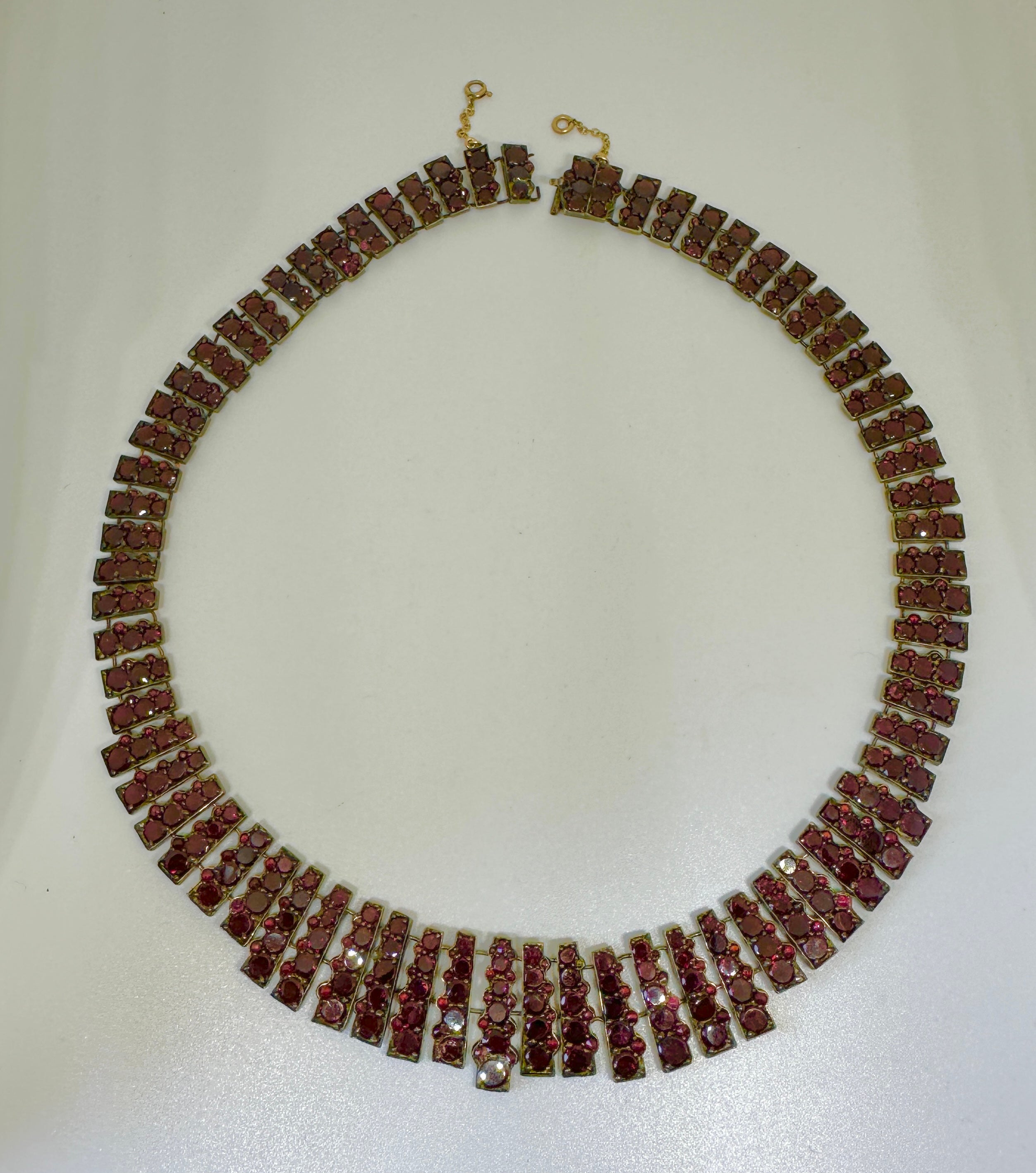 THIS IS AN ABSOLUTELY GORGEOUS AND VERY RARE 16 INCH ANTIQUE VICTORIAN BELLE EPOQUE BOHEMIAN GARNET COLLAR NECKLACE WITH SUPERB EARLY FLAT CUT DEEP RED WINE GARNETS OF THE HIGHEST QUALITY DATING TO CIRCA 1850-1880. THE NECKLACE IS MAGNIFICENT.
This