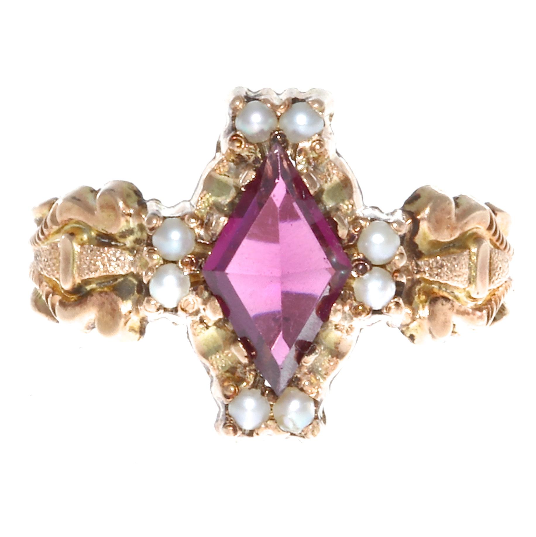 This Victorian ring features a garnet with a lovely royal purple color. The garnet weighs approximately 0.85 carats accented with 10 pearls.  The ring is crafted in 14k gold, size 5 1/4 and may easily be re-sized to fit.  Circa 1800's.
Flawless