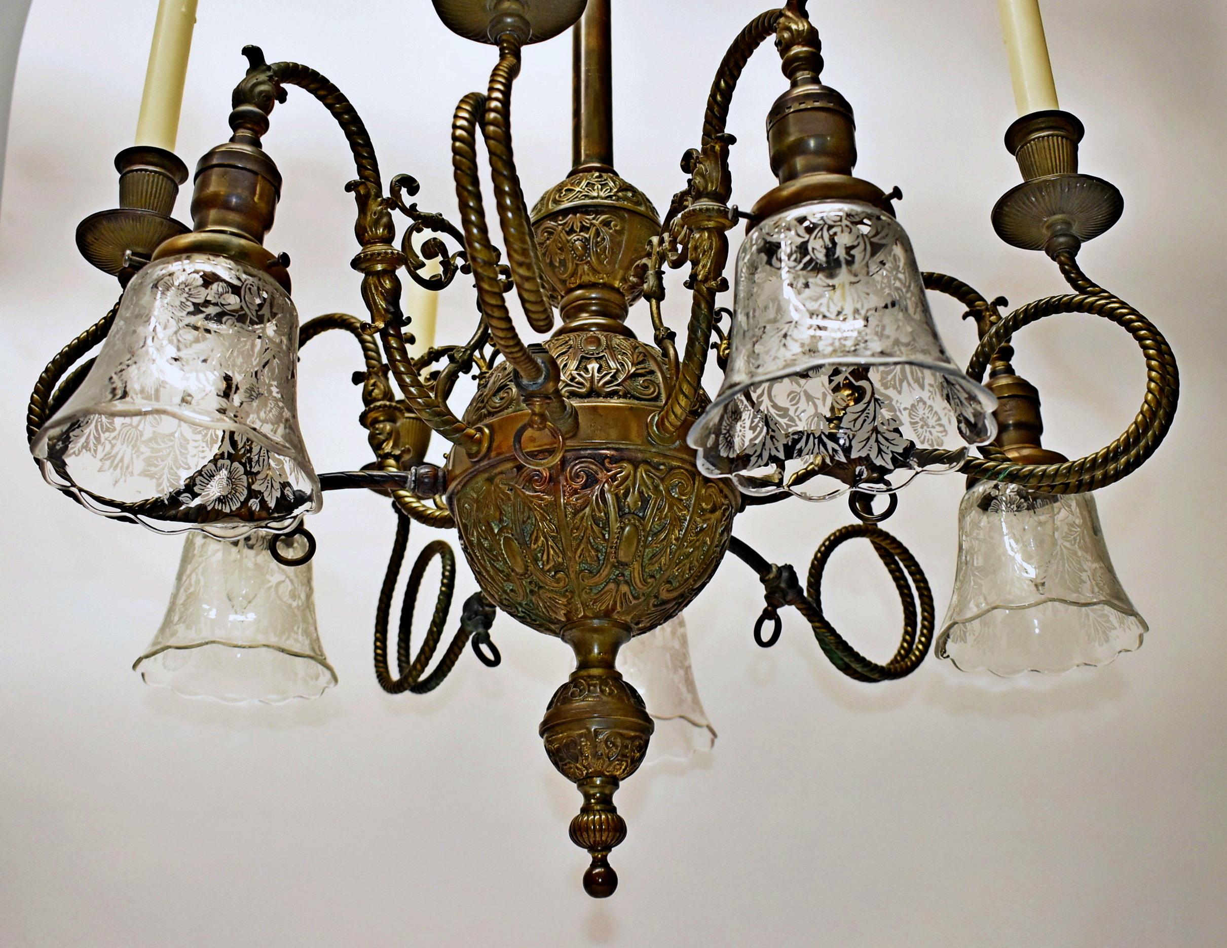 Victorian Gas & Electric Brass Chandelier. Circa 1890's. Rewired. Very ornate with heavily embossed beautiful patina. 5 electrified arms with etched glass shades included. 5 gas light arms could be electrified or made into gas. Great Vintage