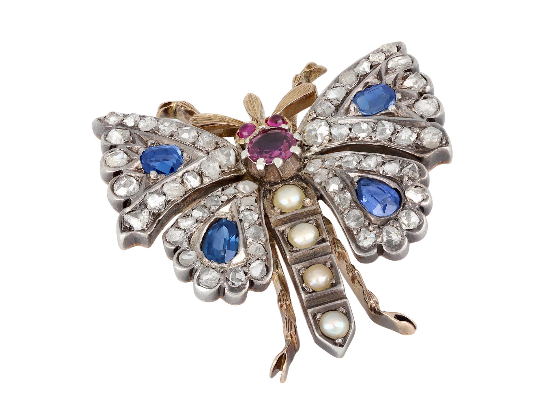 Victorian gem set butterfly brooch/pendant. Centrally set with a round old cut natural unenhanced ruby in a closed back cut-down setting with an approximate weight of 0.30 carats, additionally set with two round cabochon cut natural unenhanced