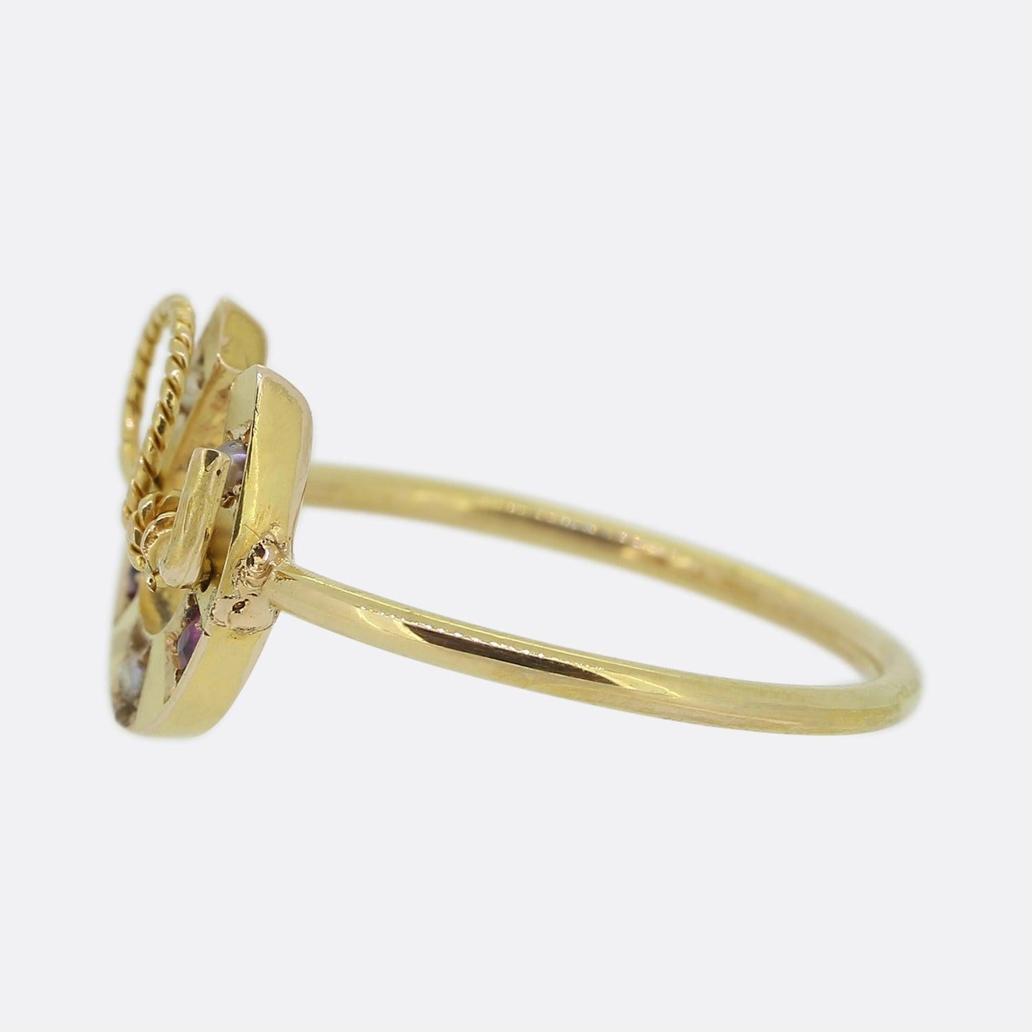 Here we have a 15ct yellow gold ring that originally dates back to the Victorian era. Th head of this piece has been crafted into the shape of a horseshoe and riding crop with neatly set pink sapphires and white seed pearls individually nestled