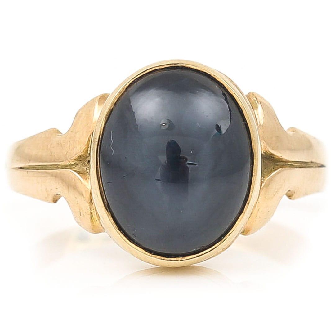 A stylish Victorian gentleman’s 9ct gold signet ring dating from circa 1900 with an impressive oval blue synthetic star sapphire. The sapphire under certain lights will show a central star which dances in the light. The shoulders are designed in s