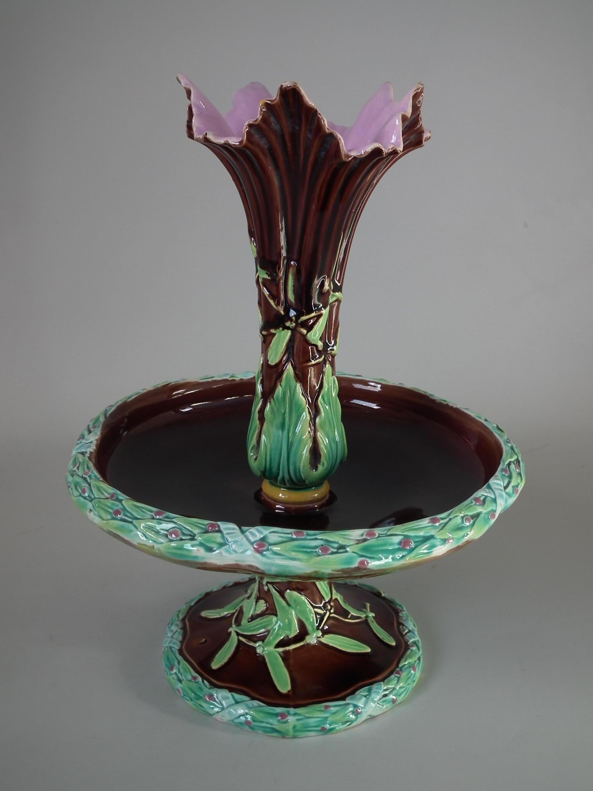 George Jones Majolica epergne which features mistletoe. Brown ground version. Coloration: Brown, green, pink, are predominant. Bears a pattern number, '6'.