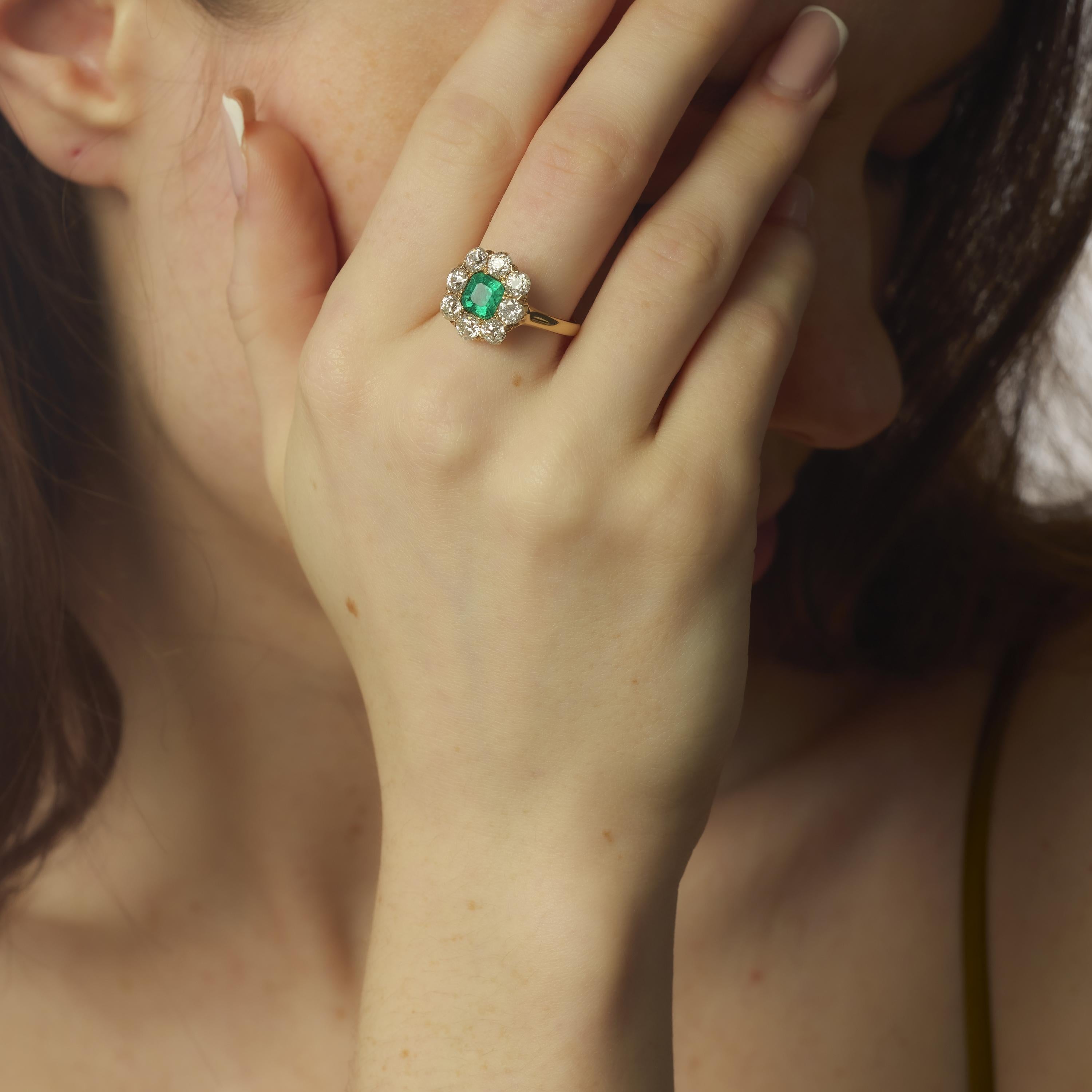 This remarkable Victorian ring features a vibrant 1.25 carat Asscher cut Colombian emerald, certified by GIA (#5231598388), radiating natural beauty with its richly saturated hue. The emerald is enhanced by F2 clarity treatment and is gracefully