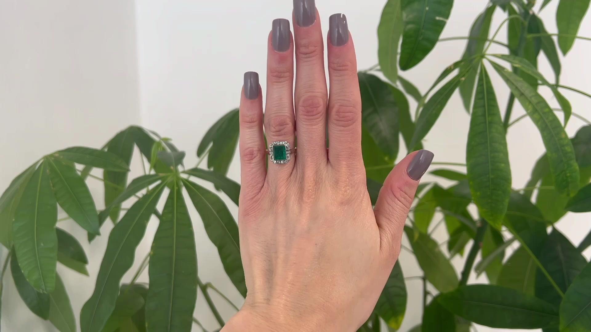 One Victorian GIA Colombian Emerald Diamond Silver 14k Yellow Gold Cluster Ring. Featuring one GIA octagonal step cut emerald weighing approximately 1.65 carat, accompanied with GIA #2225660947 stating the emerald is of Colombian origin. Accented by