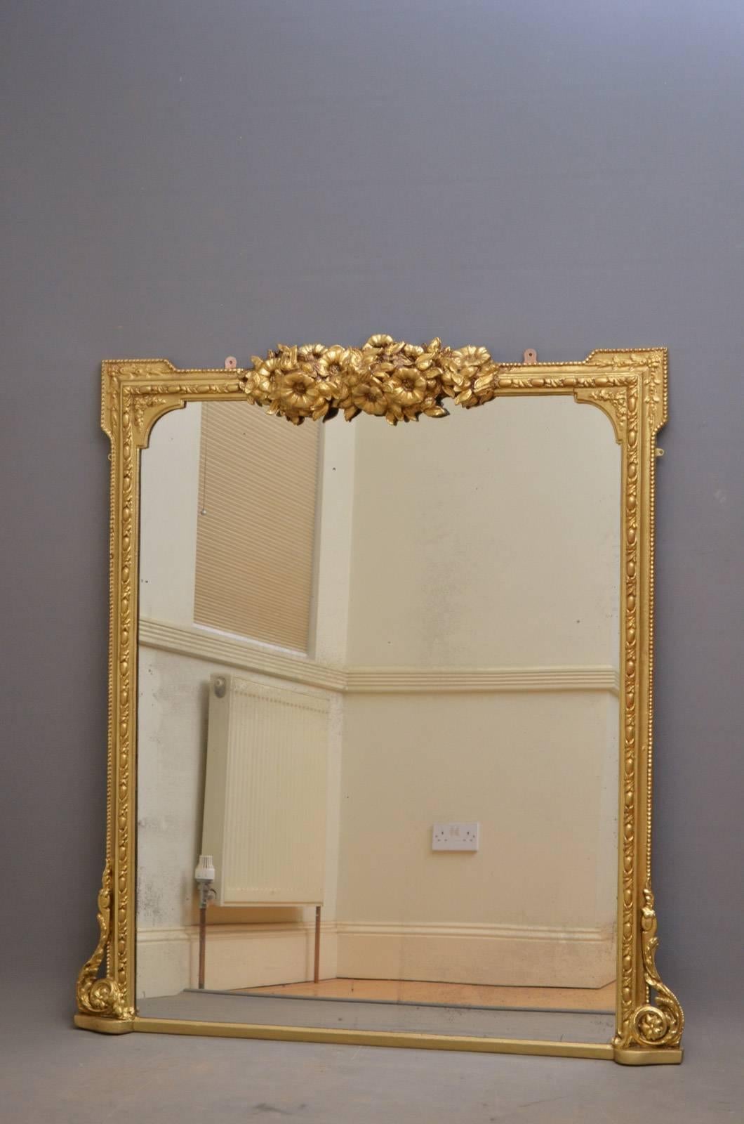 K0288, Victorian gilt overmantel mirror, having flower decoration to centre and original mirror plate with foxing in carved frame. This antique mirror has been refinished and is ready to place at home, circa 1870.
Measures: H 54.5