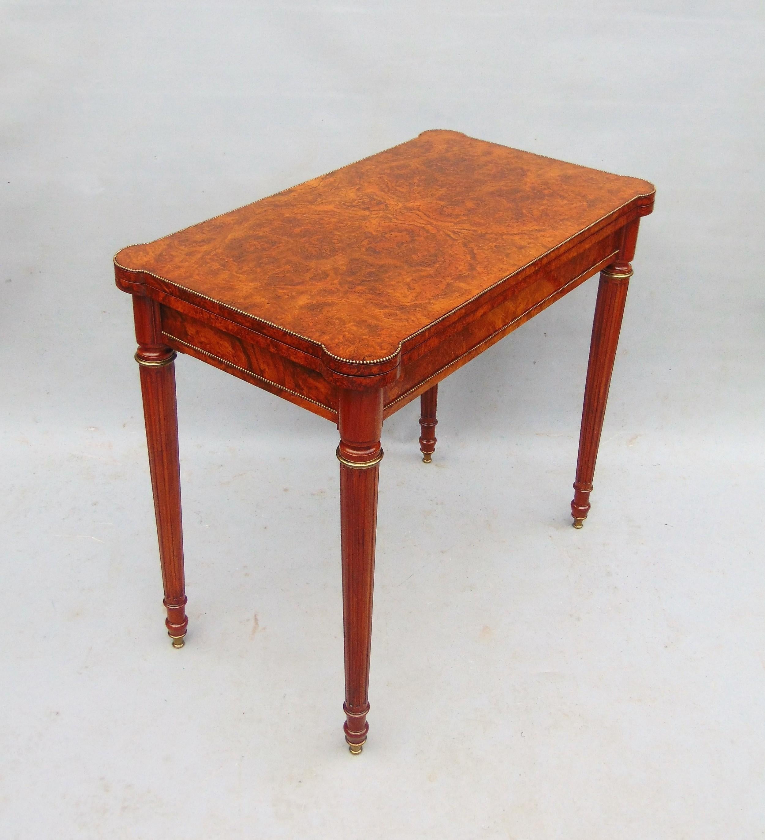 A superb quality Gillows Walnut Card Table with fabulous Burr veneers and fine Gilt Bronze mounts the back legs pull out to reveal a Mahogany lined drawer which acts as a support to the fold over top revealing green baized interior which has