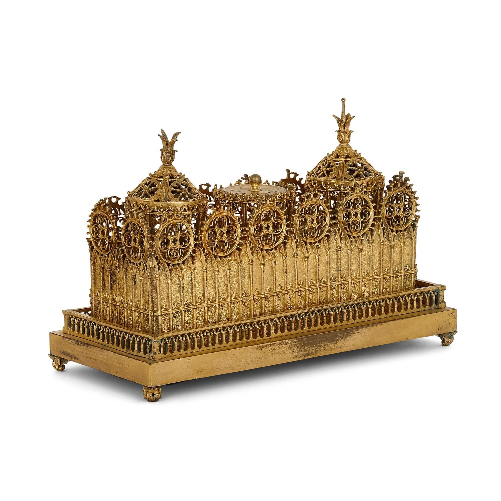 Victorian gilt inkstand desk set in the Gothic style
English, 19th Century
Height 19cm, width 27cm, depth 12.5cm

This wonderful inkstand is a fine piece of Victorian period design. The stand in designed in the Victorian Gothic style, with the body