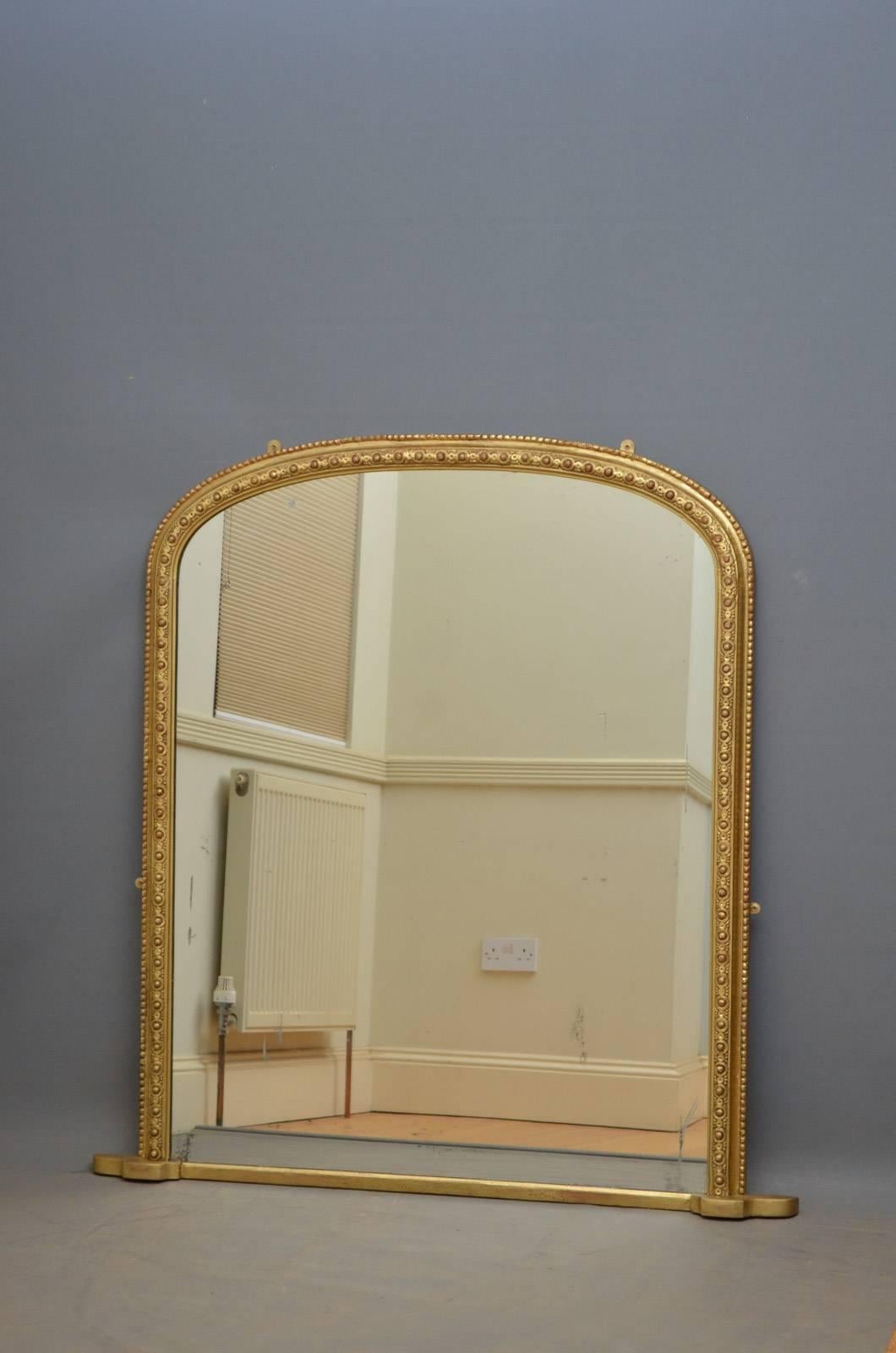 K0319, Victorian giltwood wall mirror, having original mirror plate with some foxing and imperfection in finely decorated frame. This antique mirror has been refinished, it retains its original panelled backboards and mirror plate which can be
