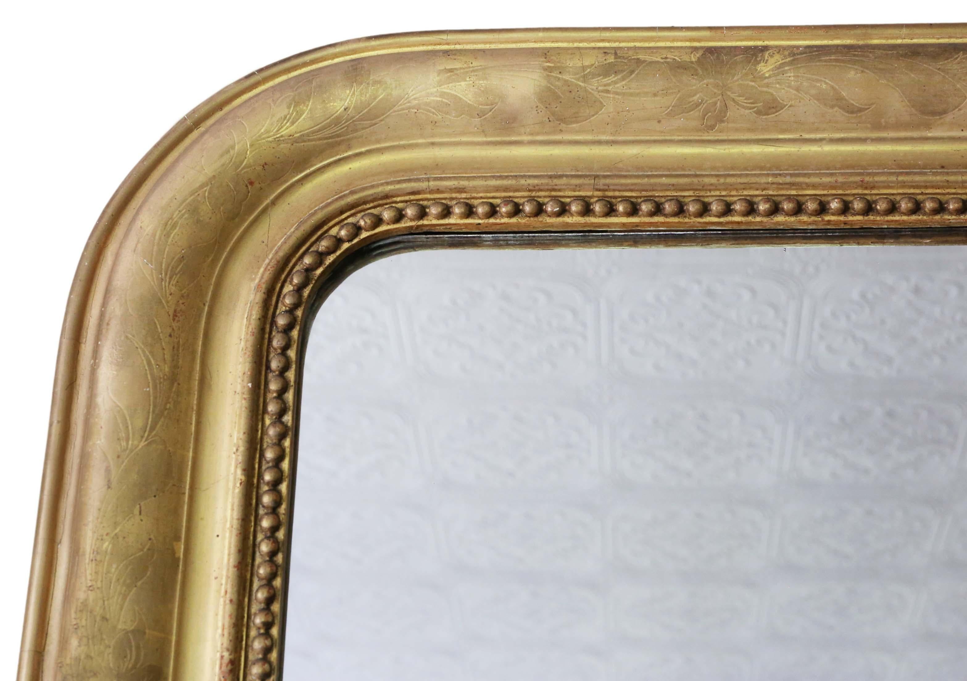 Antique quality Victorian gilt overmantle or wall mirror, circa 1890.
This is a lovely mirror, with some original gilding remaining.
Would look amazing in the right location. No woodworm.
The original mirrored glass with minor imperfections and