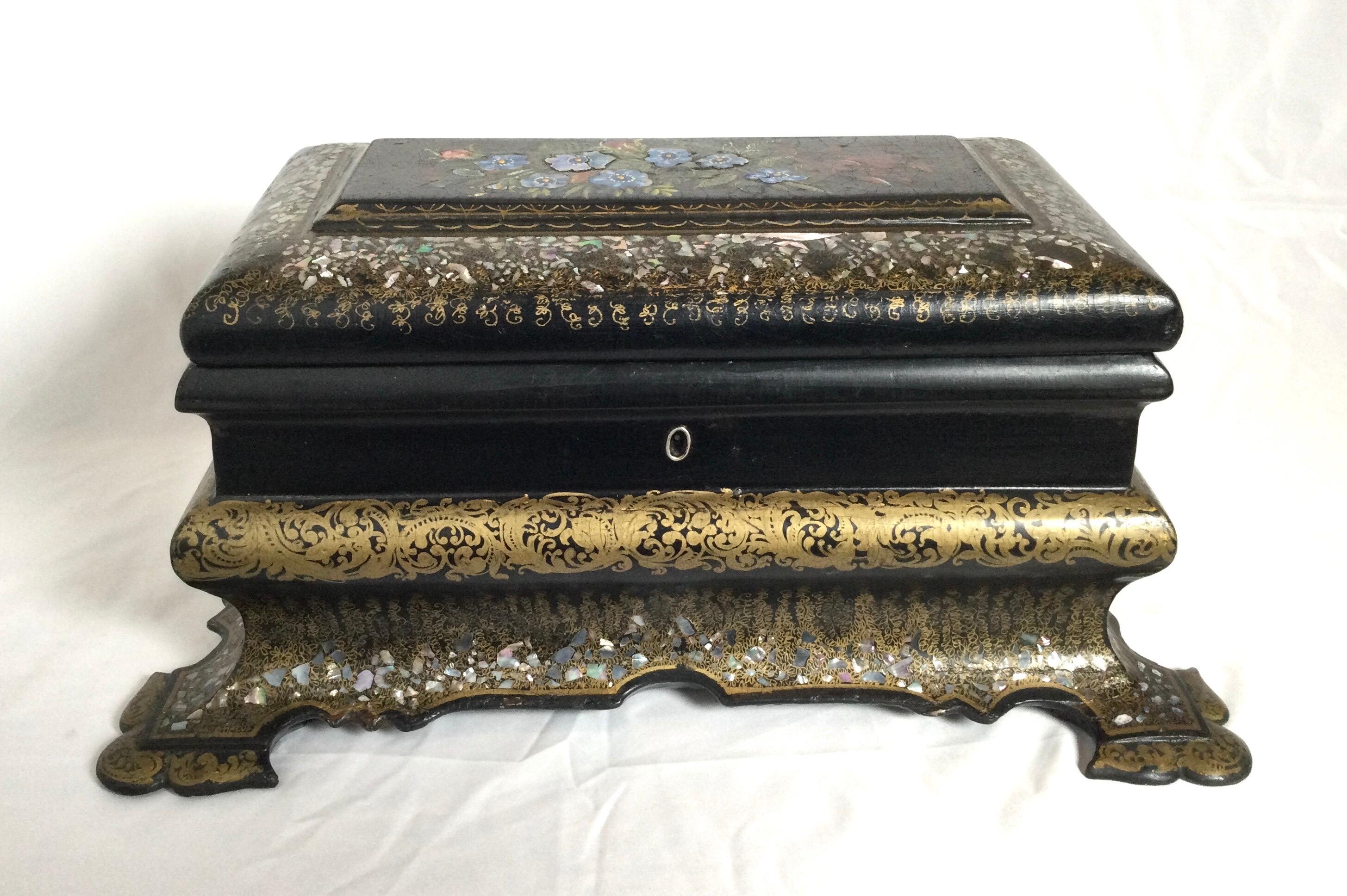 Victorian gilt and painted paper mâché with mother of pearl tea caddy. Large very stylish body shape with lots of gold leaf and mother of pearl. Beautiful hand painted flowers on top. Very unusual turtle foot shaped feet. Measures: 15