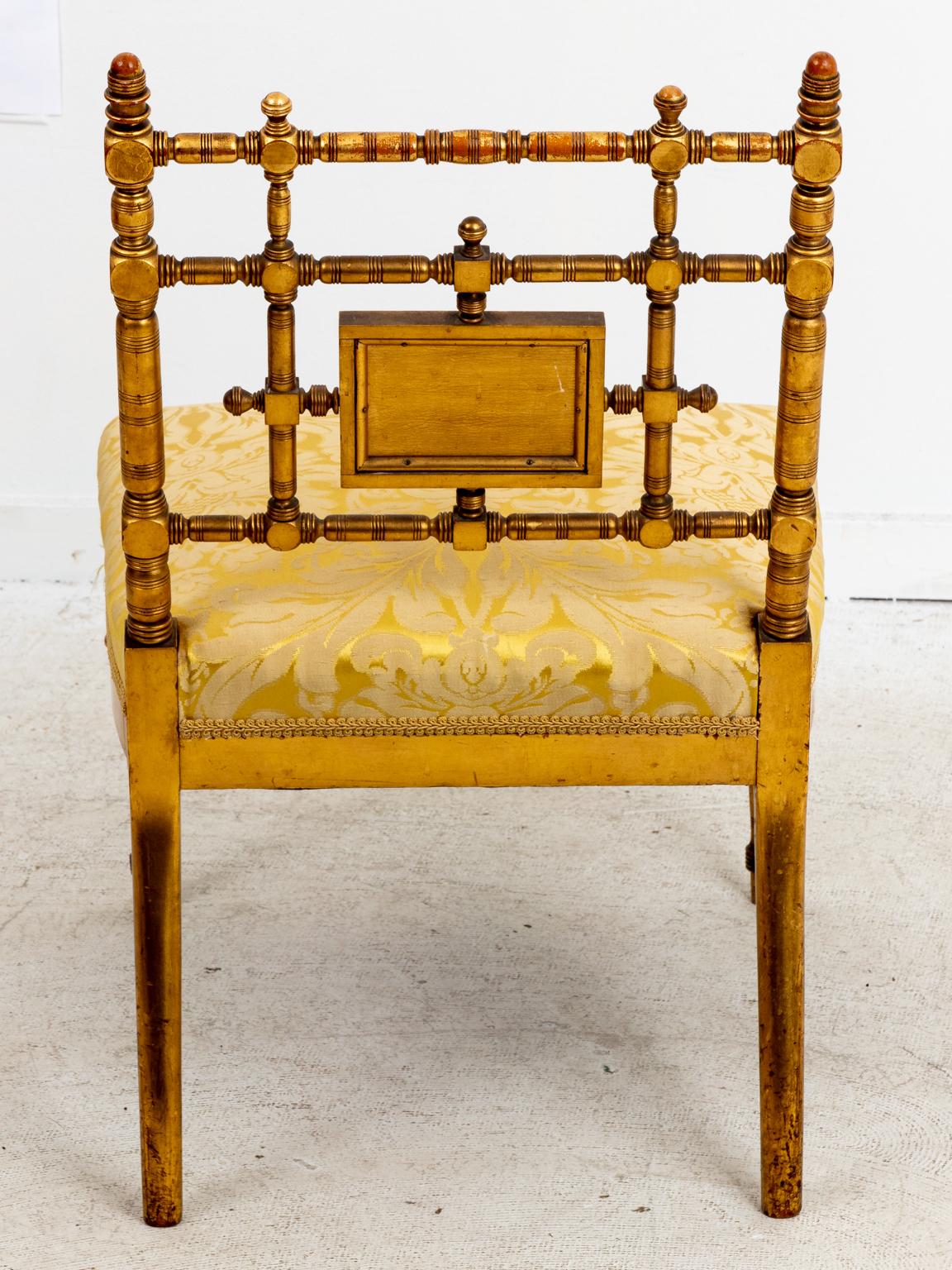 Victorian Eastlake style giltwood slipper chair with painted floral illustrated panel on the seat back and an upholstered seat, circa 19th century. The piece also features ring turned wood throughout. Please note of wear consistent with age
