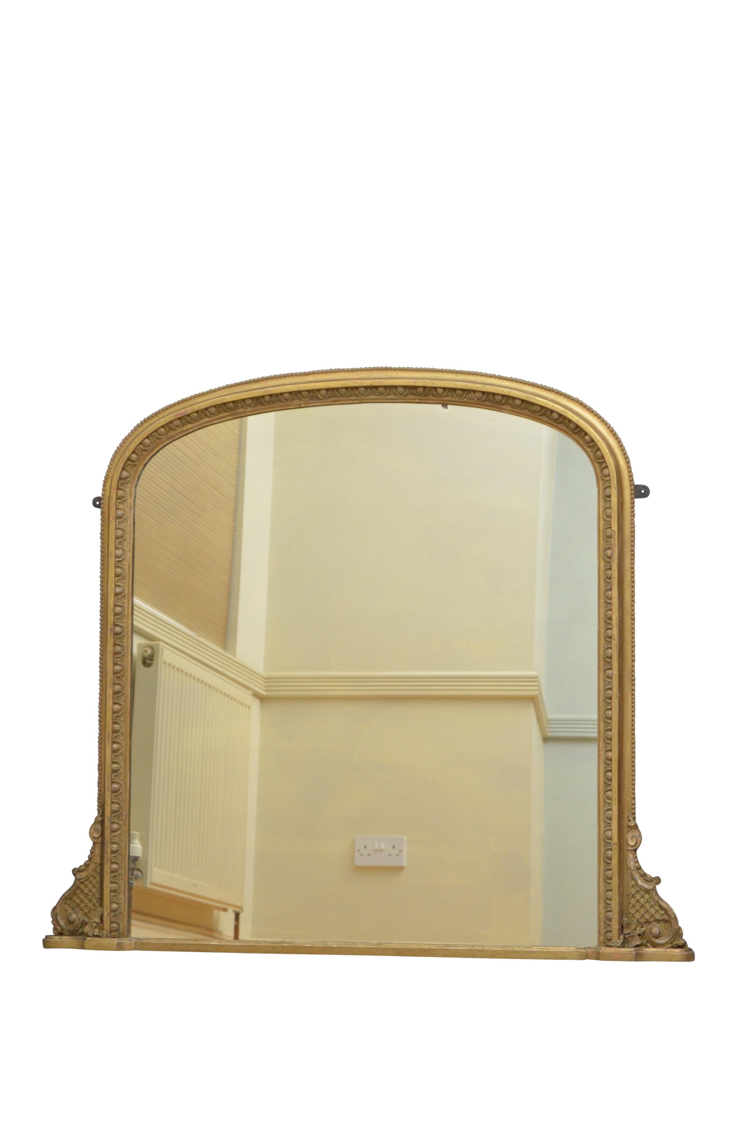 K0381 Victorian gilded wall mirror in Regency taste, having original mirror plate with some foxing in egg and dart carved giltwood frame with fine scrolls to base. This antique mirror retains its original glass, finish and backboards, ready to place