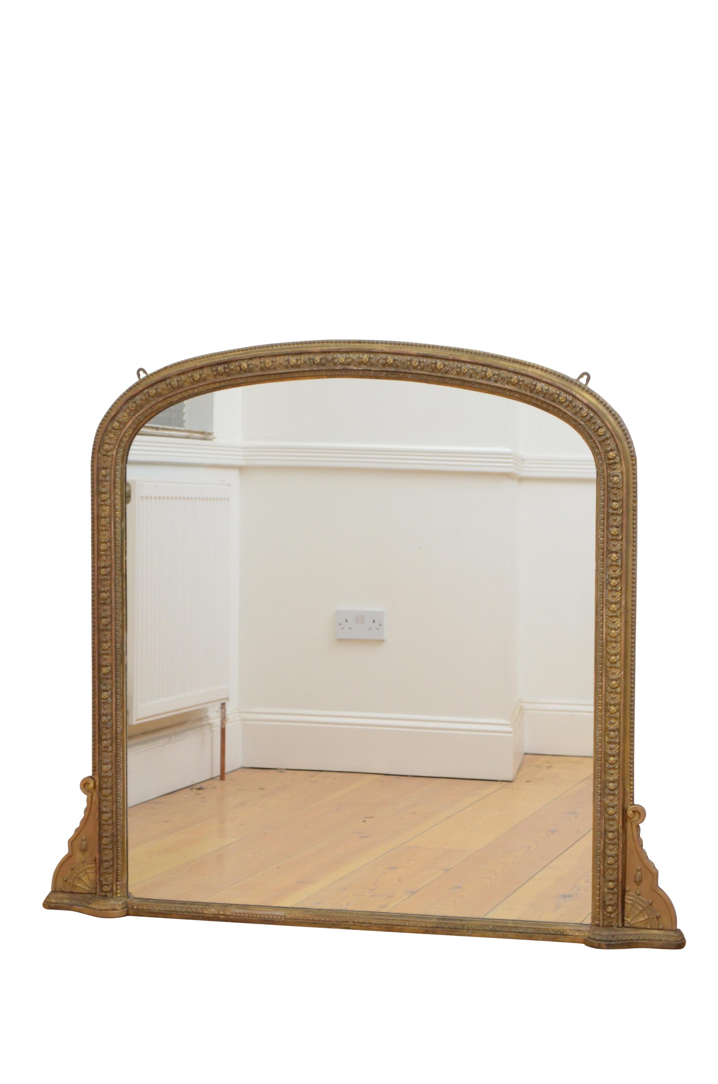 K0578 Victorian gilded wall mirror of low design, having carved frame with beaded edge and scrolls to the base. This antique mirror retains original gilt with touching up over the years and original backboards fitted with hanging brackets, all in