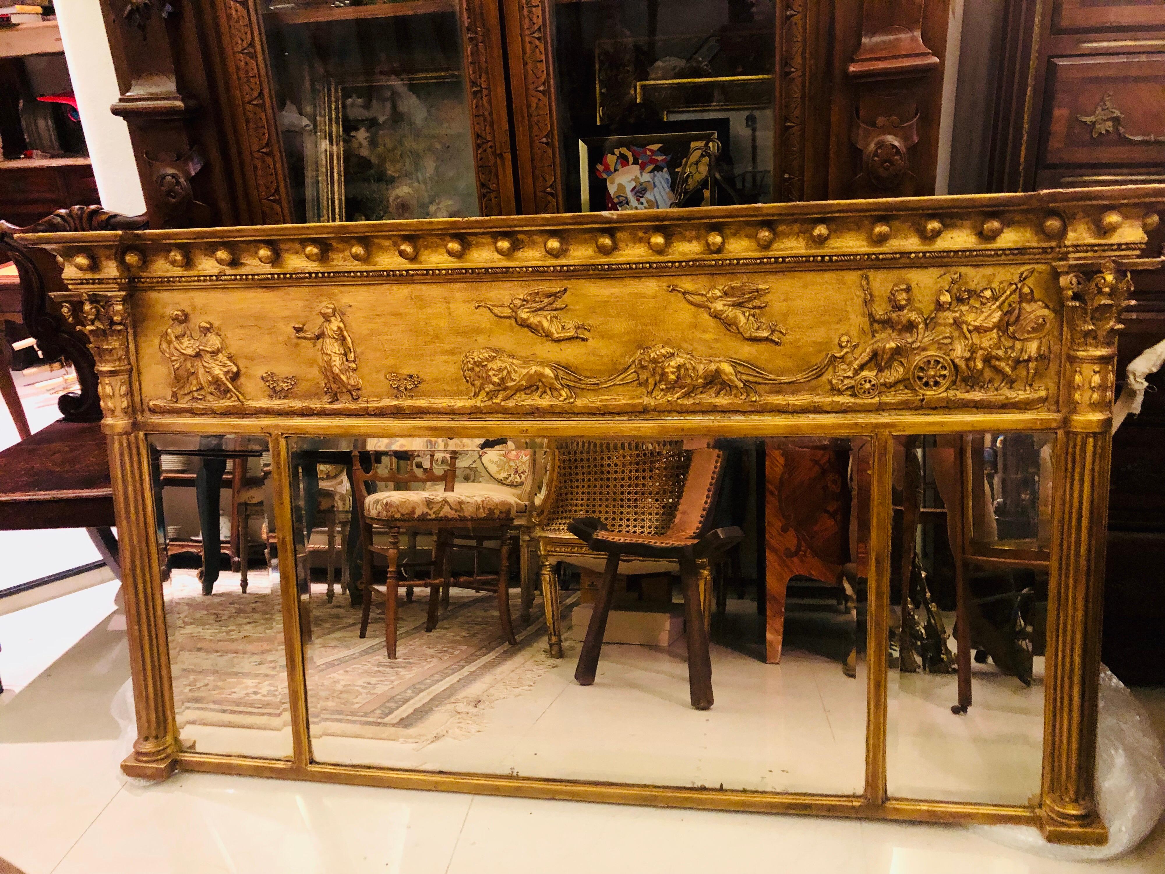 19th century Victorian giltwood and gesso landscape overmantel mirror, with three bevelled rectangular plates flanked by Corinthian cluster columns, the frieze decorated with Aurora leading Apollo's chariot, with a ball decorated frieze. Absolutely