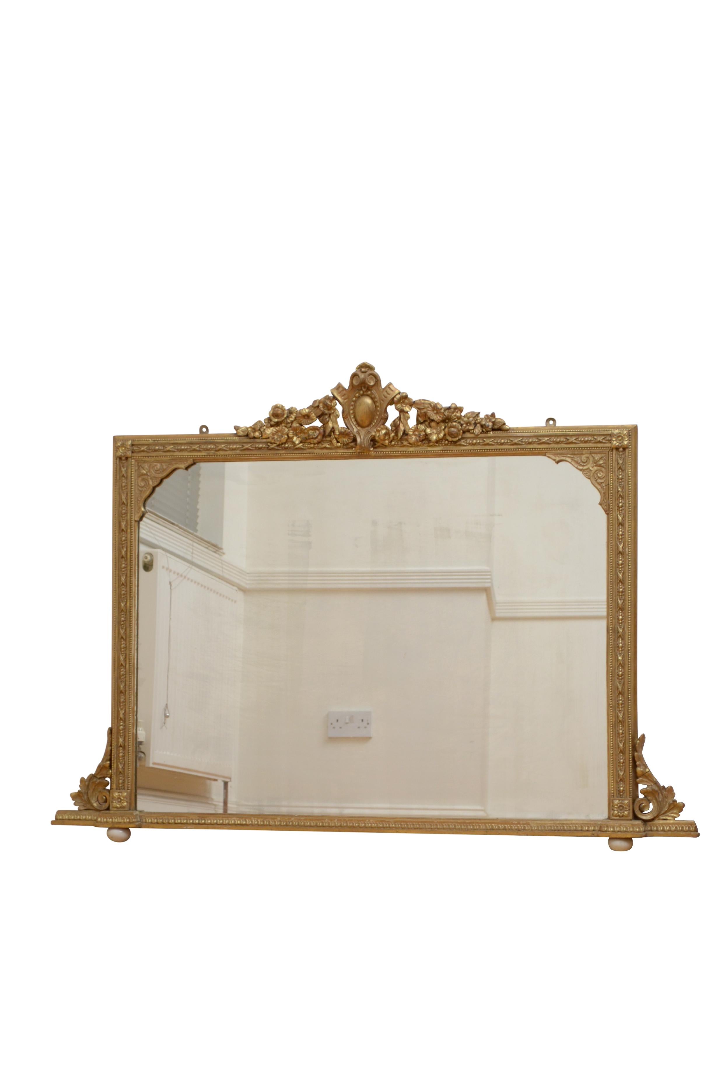 0584 Attractive Victorian mantel mirror in giltwood, having original glass with some foxing in gilded frame with beaded, and carved decoration, flower motifs to corners and floral centre crest, all flanked by leafy scrolls. Standing on original