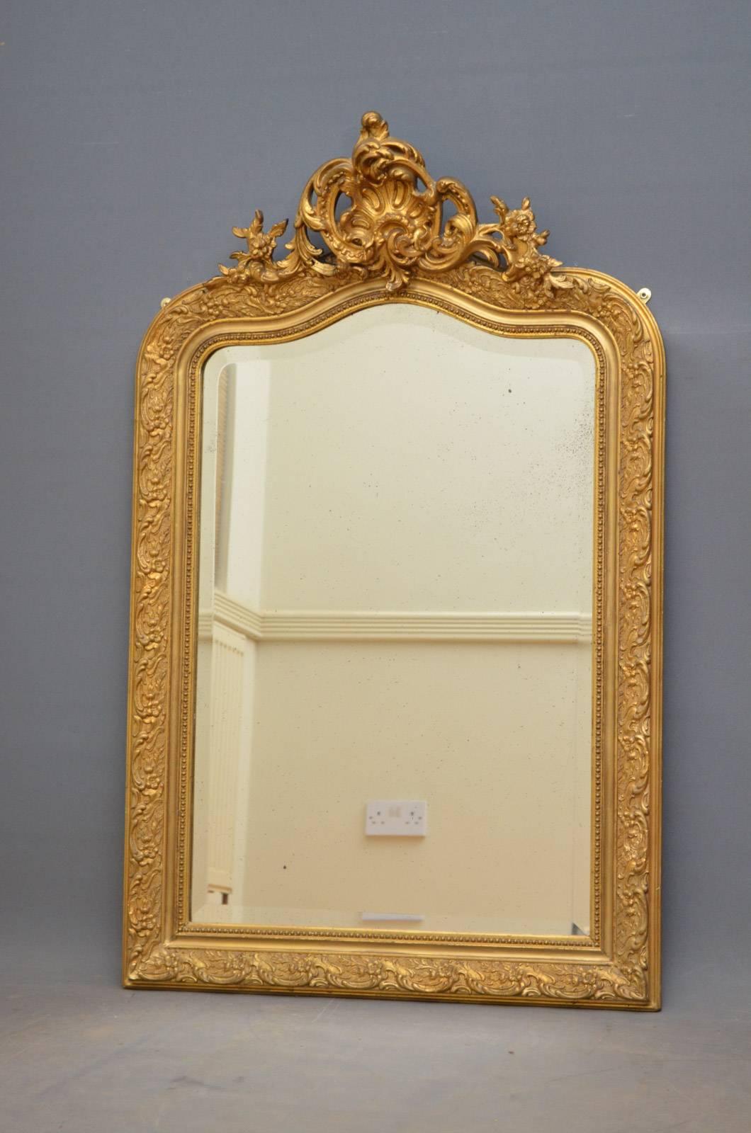 K0302, 19th century French mirror, having original bevelled edge glass with some foxing in finely decorated moulded frame with carved cartouche to centre. This antique mirror retains its original mirror plate and gilt, all in excellent home ready
