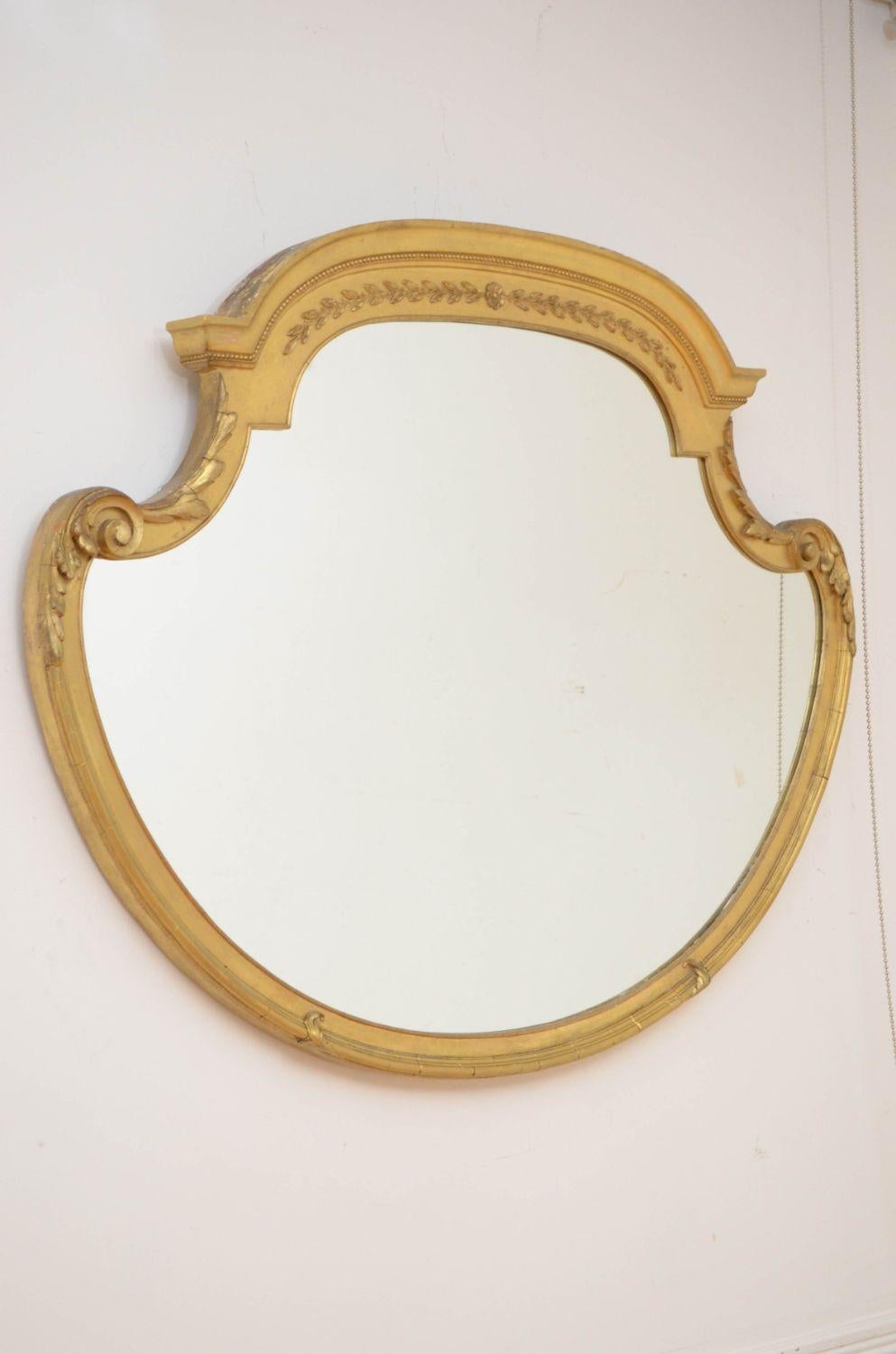Sn4723 Attractive Victorian gilded wall mirror, having a replacement glass in shaped and moulded frame with beaded edge and harebell decoration. This antique mirror retains its original gilt, all in wonderful home ready condition. c1880

Measures: