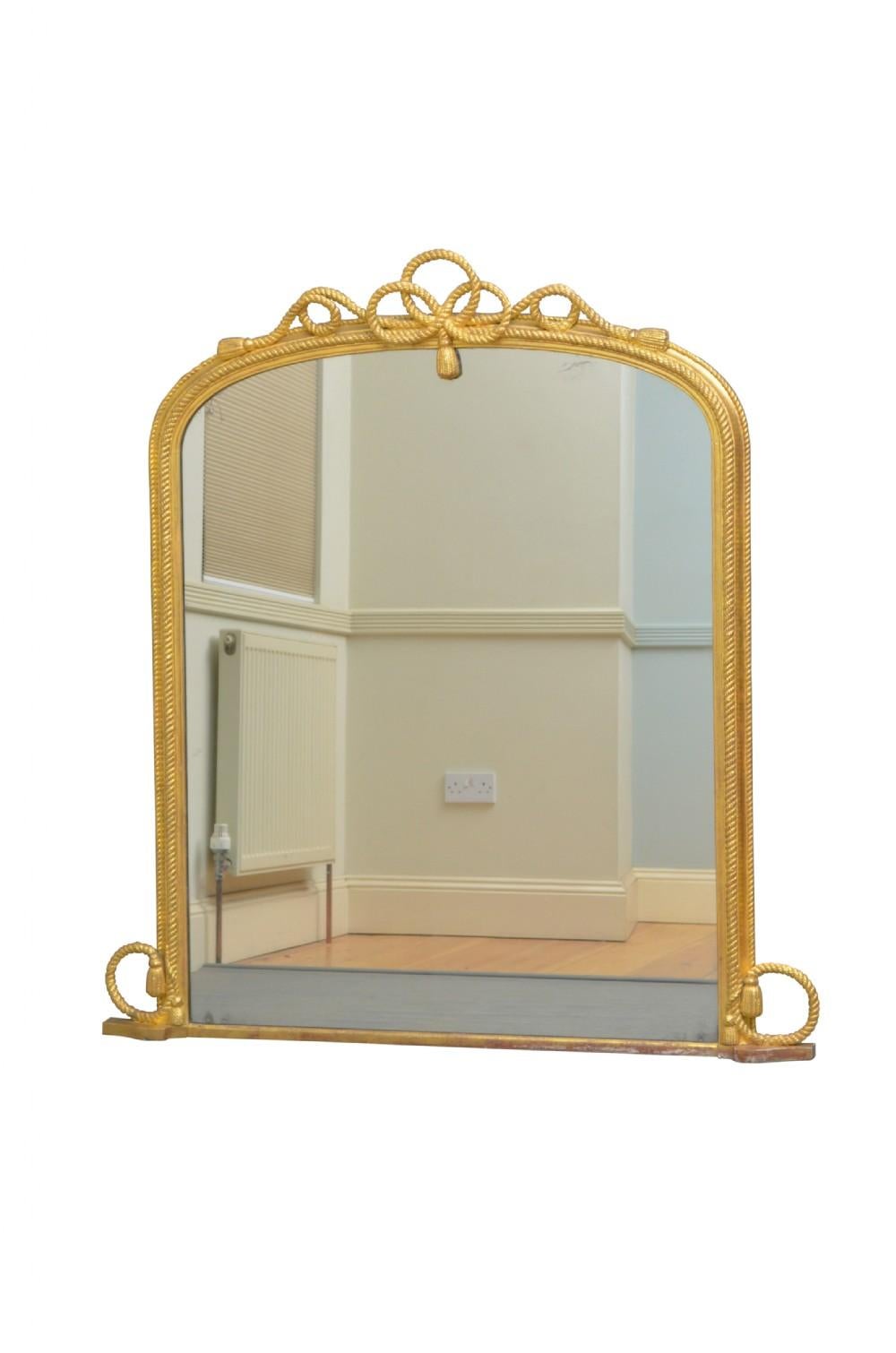 K0428 Stylish Victorian gilded wall mirror, having original glass with some foxing in gilded frame with rope decoration throughout. This overmantel mirror retains original glass, gilt and backboards. Ready to place at home. c1880
Measures: H56