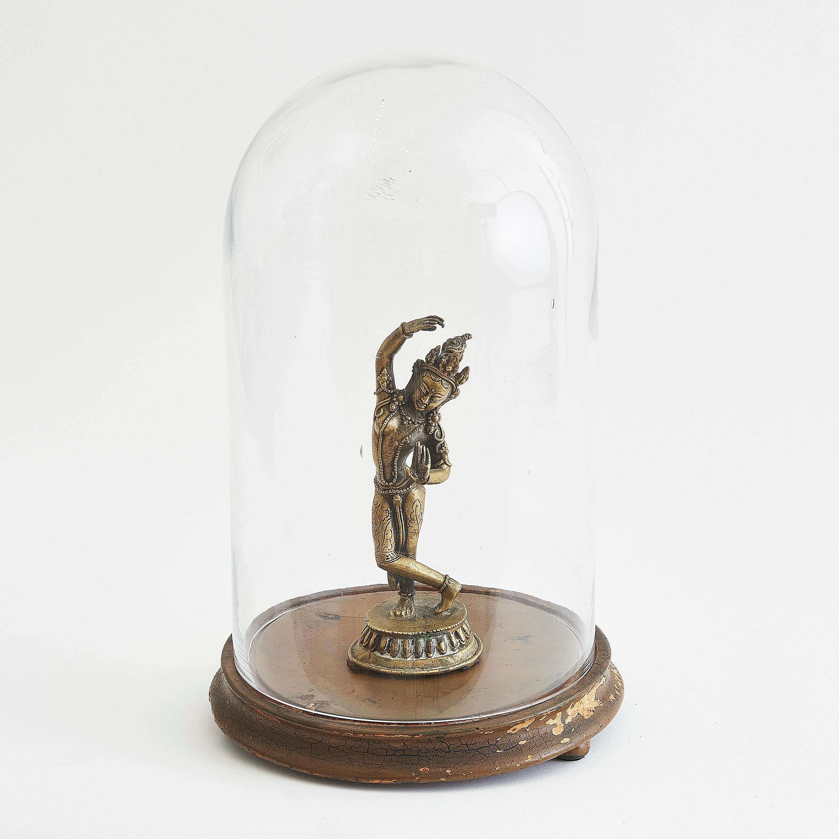 This decorative piece features a finely detailed brass figure of Queen Maya in a classical dance pose, on display in an elegant 19th-century Victorian glass dome. 

These items can be sold separately, please contact us. 

Dimensions: 

Dome