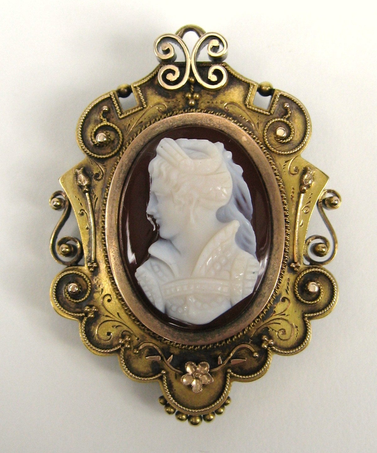 Victorian agate cameo brooch with hair locket in the back. Set in 14K gold. The Back opens has never been used. Depicts a soldier. Tons of scroll work on the surround. Measures 2.40 in.  x 1.43 in. This is out of a massive collection of Hopi, Zuni,
