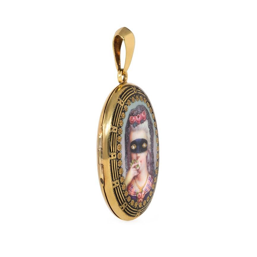 An antique gold and enamel locket featuring a painted masked lady with diamond eyes, with two interior picture compartments, in 15k.  England

Dimensions: 2