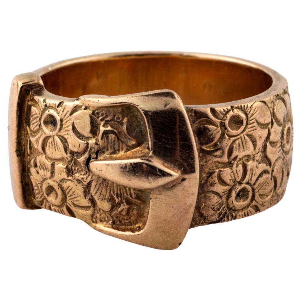 A  solid, warm tone, substantial 11.9 gram 15 Kt gold buckle ring,  like all the buckle motif bracelets of the Victorian era symbolized two people united, joined together as one. The ring is engraved with roses, the flower of love, friendship and