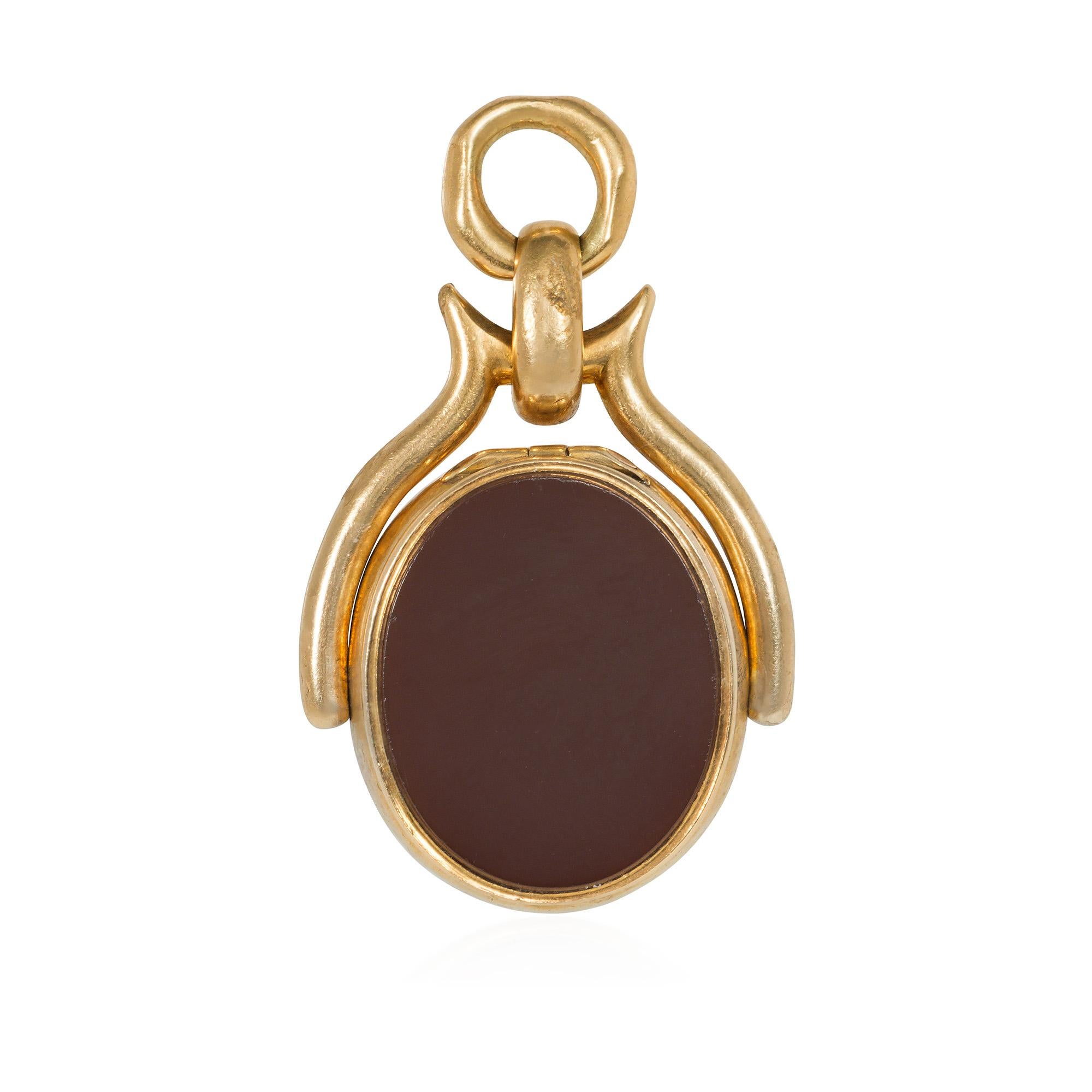 An antique Victorian period gold swivel locket pendant with an oval bloodstone panel on one side and a jasper panel on the verso, in 15k.  The hinged jasper side opens to reveal an internal compartment.  England  (Chain sold separately.)

* Free