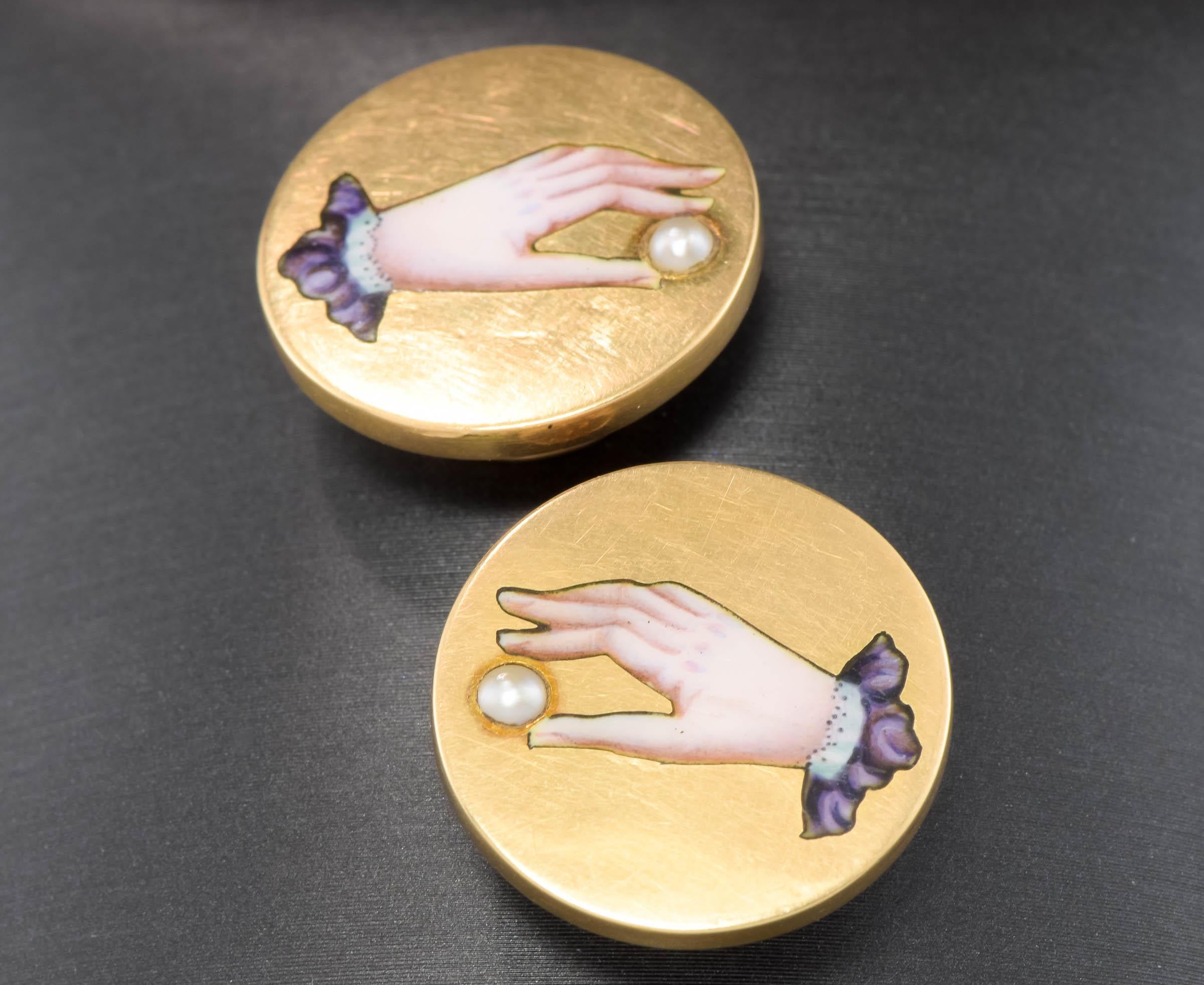 I'm delighted to offer a Victorian pair of antique button style cufflinks with lovely enamel hands holding a seed pearl.  They could also be converted into a wonderful pair of earrings or into pendants, if desired.

(please note that the first photo