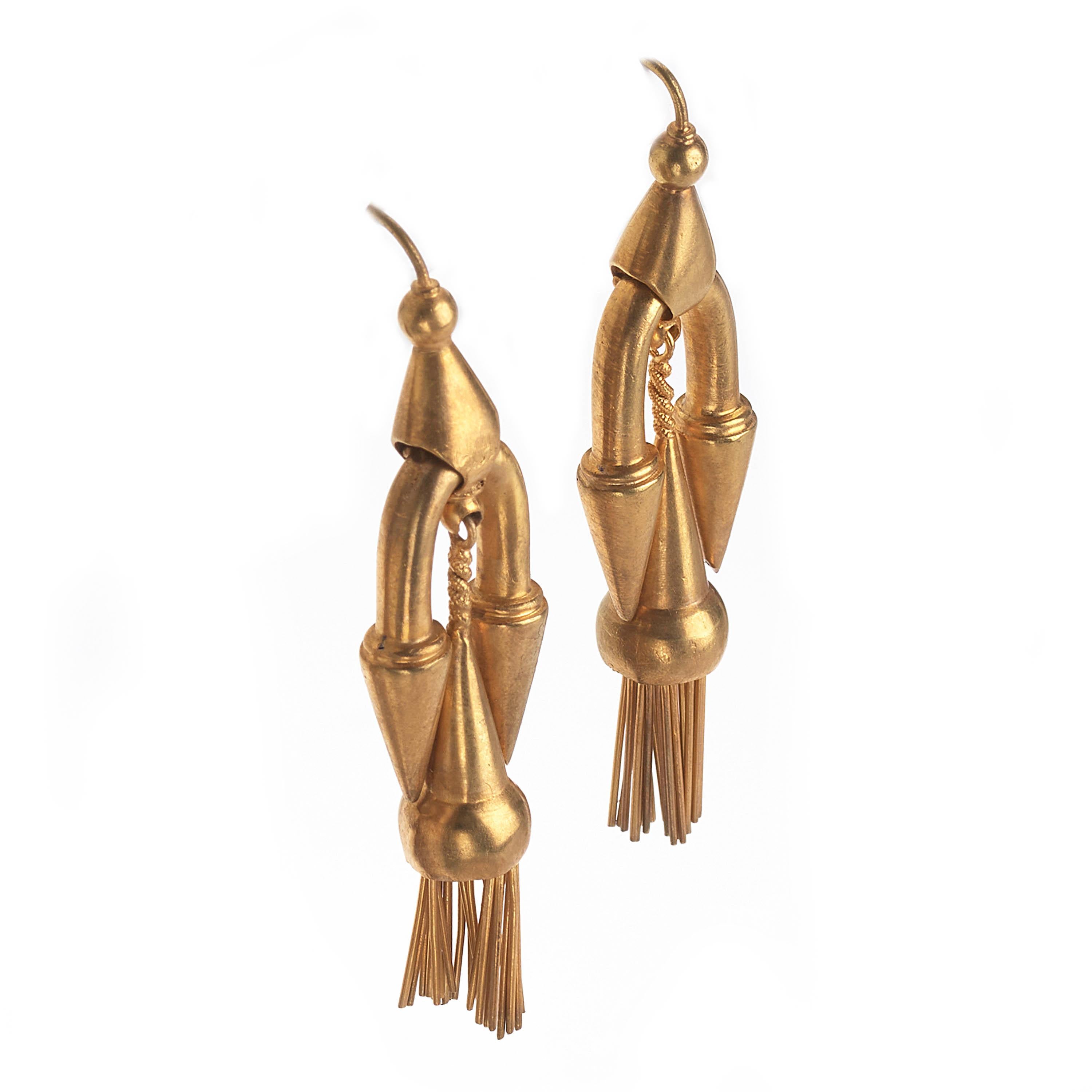 A pair of Victorian drop earrings, made in the Etruscan style, consisting of a long pendant drop, with fringed tassels, suspended by a spiked curve, with hook fittings, all in yellow gold. English, late 19th century.