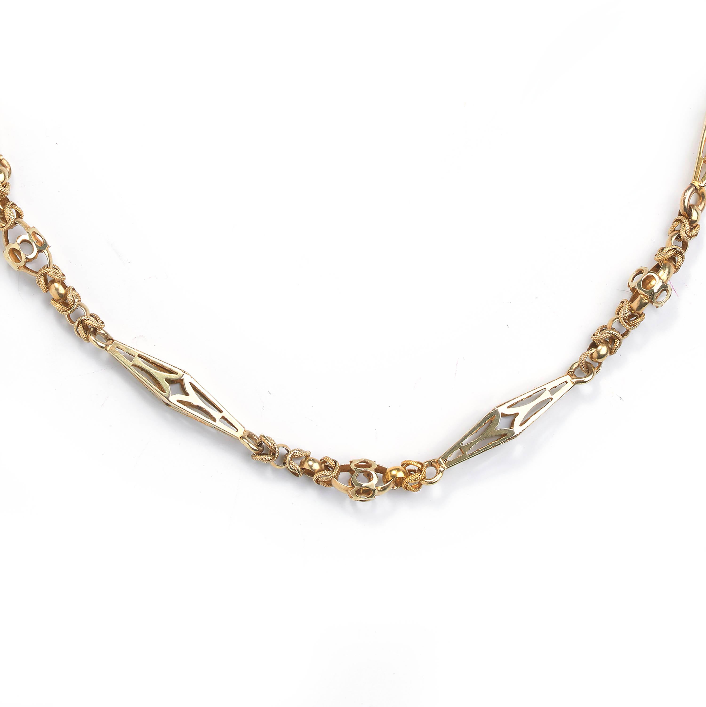 A Victorian gold fancy link long chain necklace, comprised of handmade open linked and decorative twisted interwoven links, with open pierced elongated rhombus motifs, with an engraved turquoise set torpedo rhombus clasp. Length approximately 114cm.
