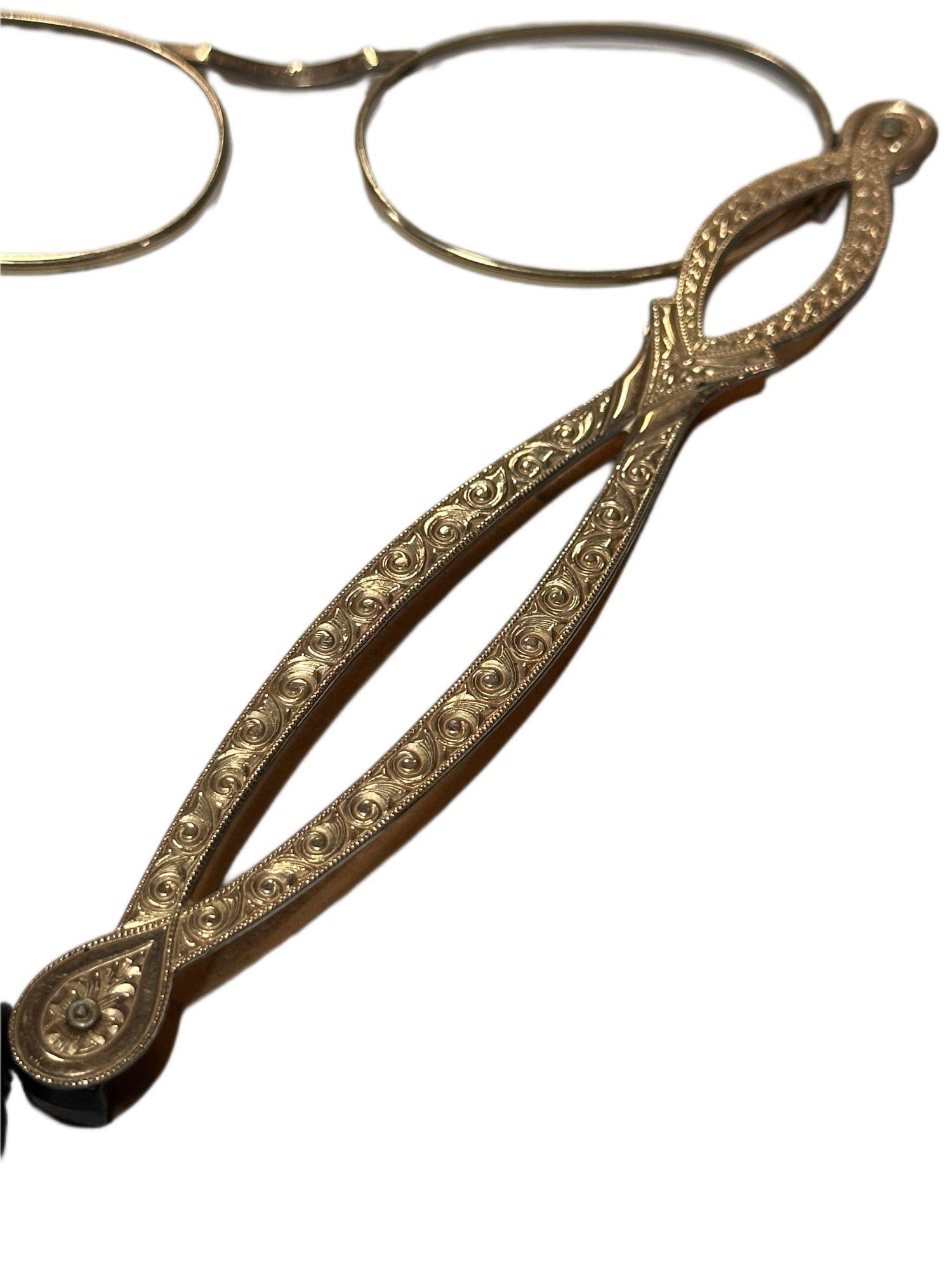 A 1/10 Filled 12K Gold filled Lorgnette is tied to a velvet string, no glass wear included. Very intricate and detailed Handles.
The Victorian lorgnette is a delicate and ornate accessory, popularized during the 19th century. Made with fine