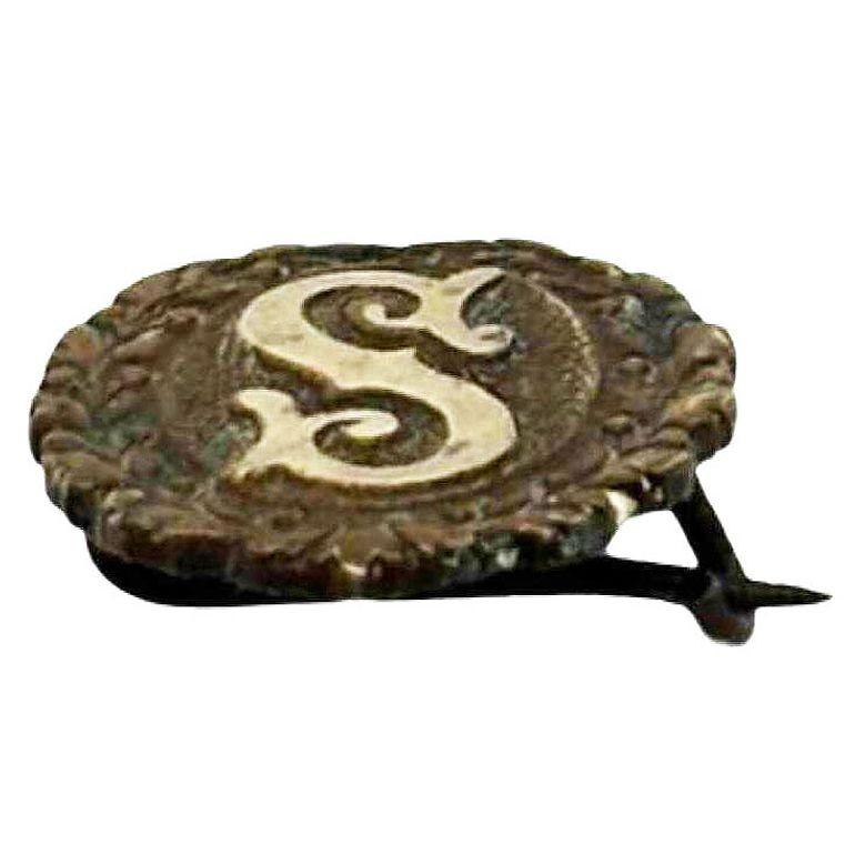Turn-of-the-century oval initial 