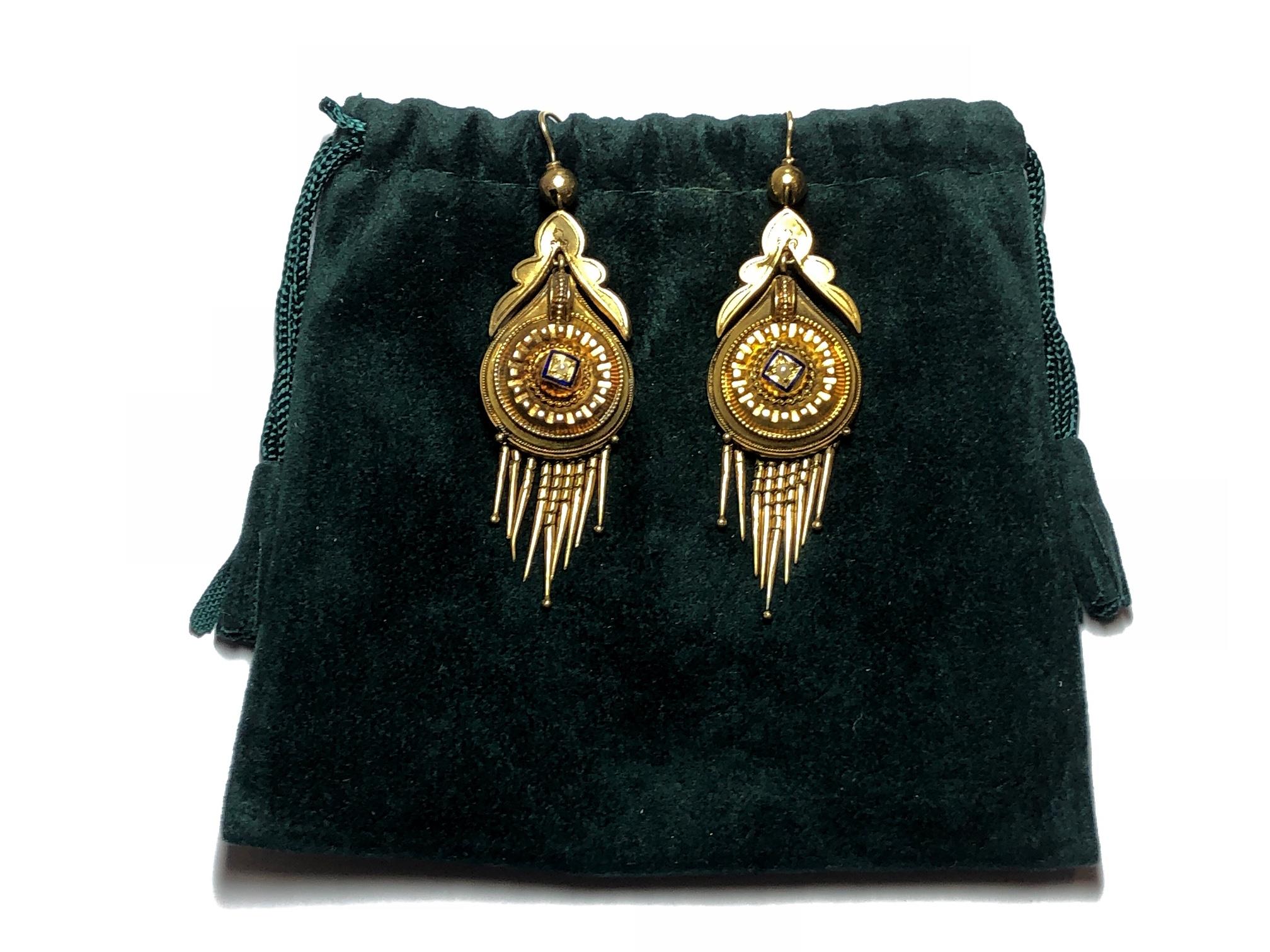 A pair of Victorian fringe earrings, centrally set with a seed pearl and blue enamel detail, with Etruscan style work, mounted in 15ct gold, circa 1875.